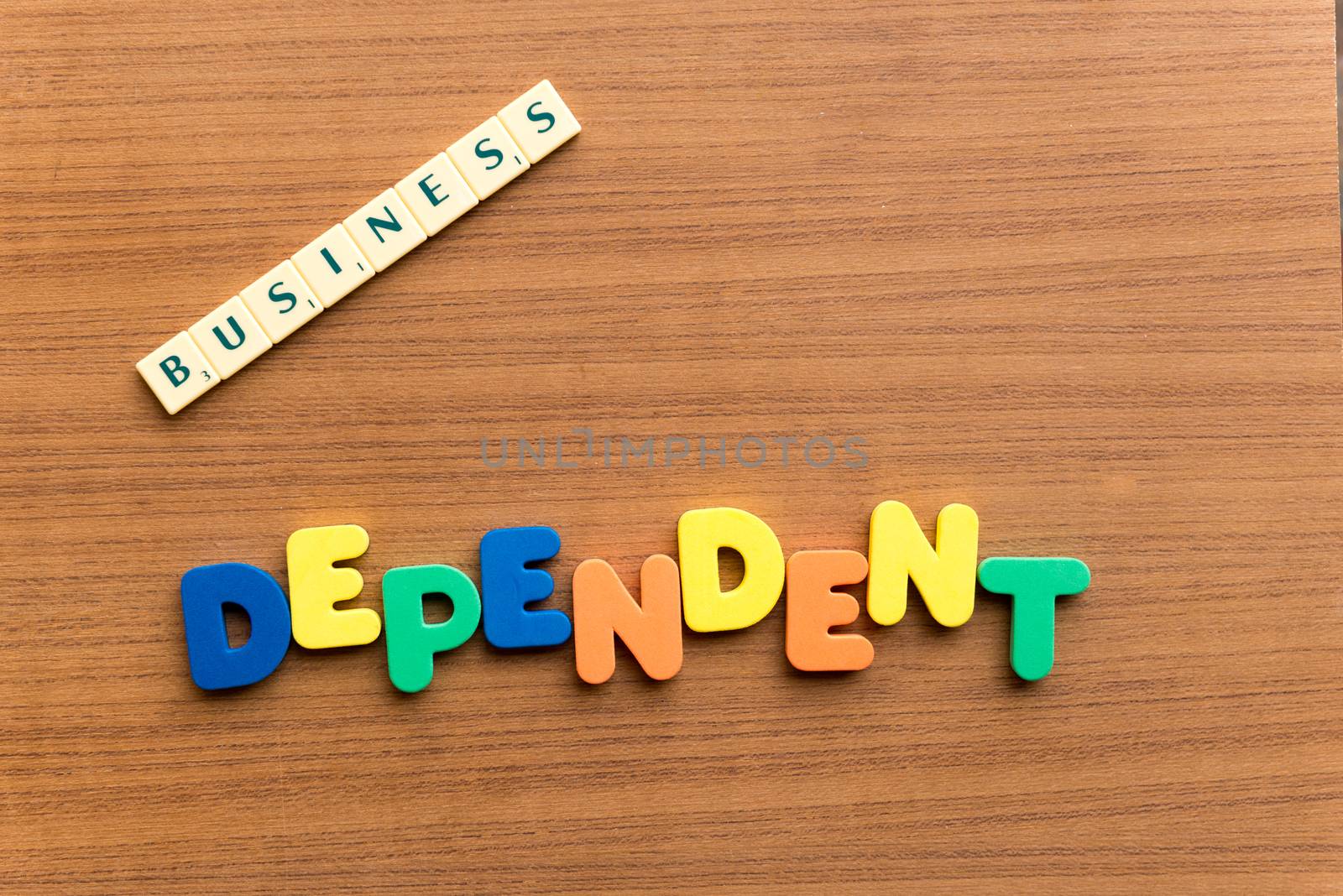 dependent colorful word on the wooden background