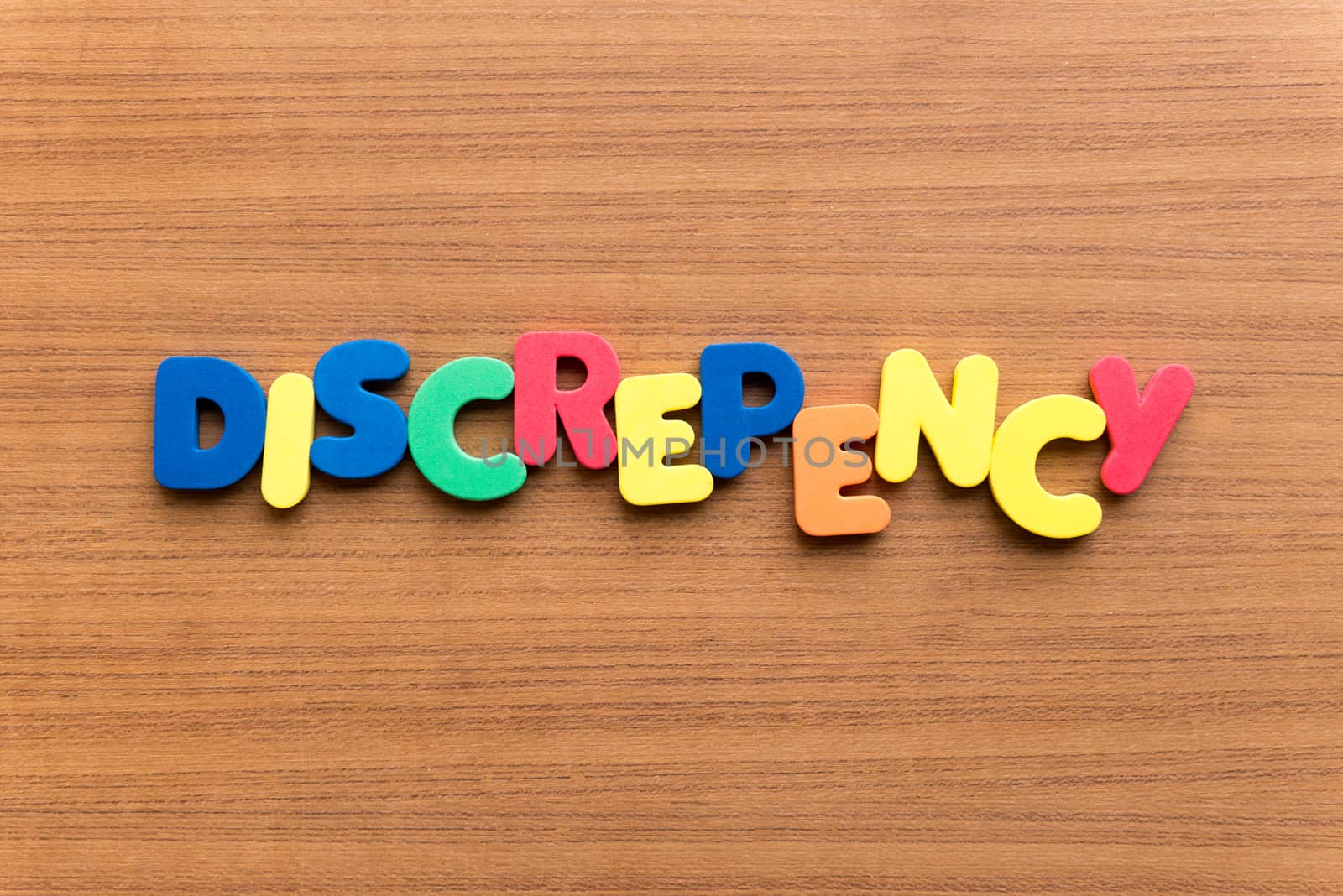 discrepency colorful word on the wooden background
