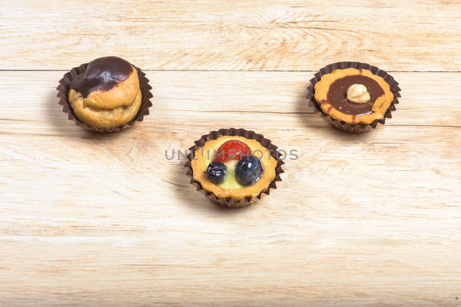 Pictured pastries on light wood background