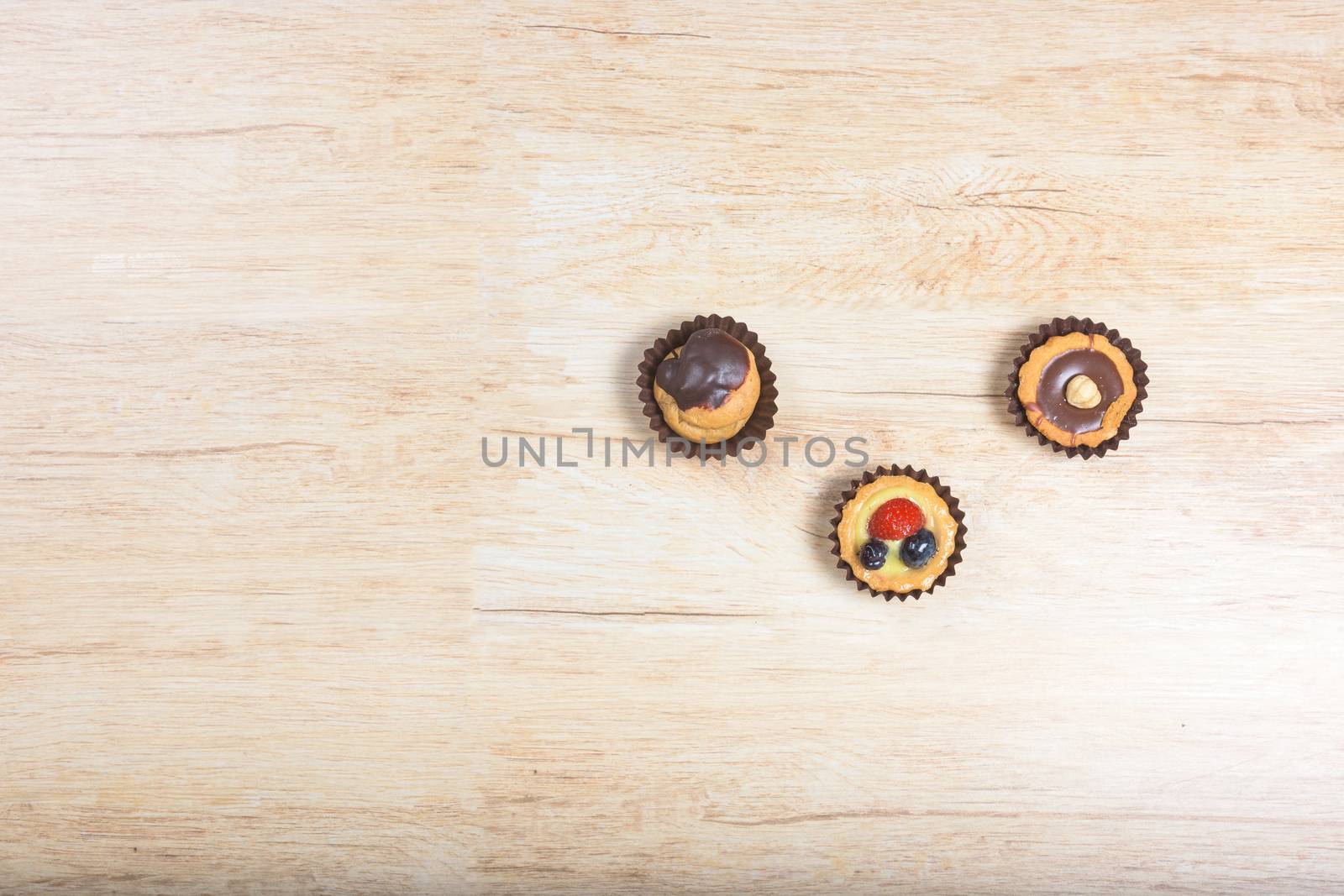 Pictured pastries on light wood background,view from above,copy space.