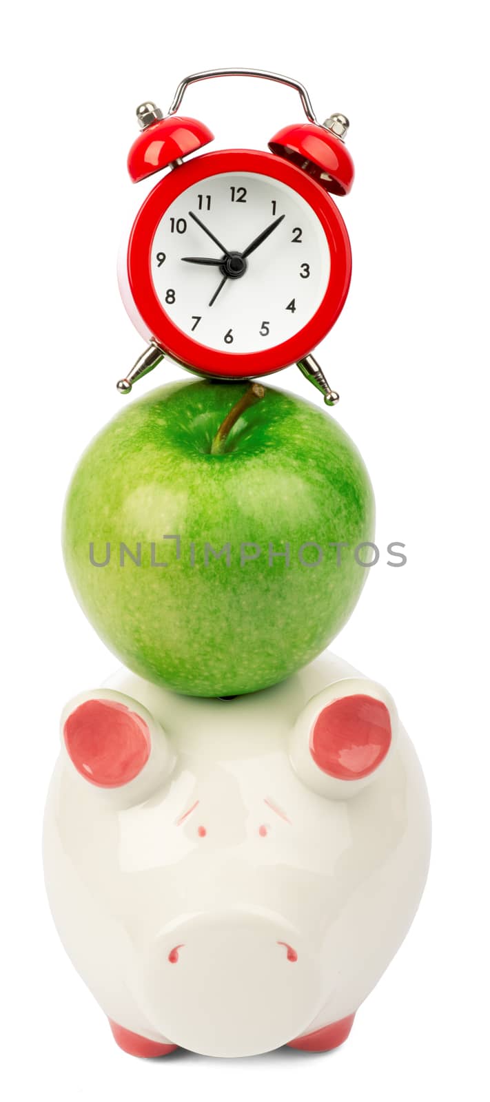 Fresh green apple with alarm clock and piggy bank on isolated white background. Business concept