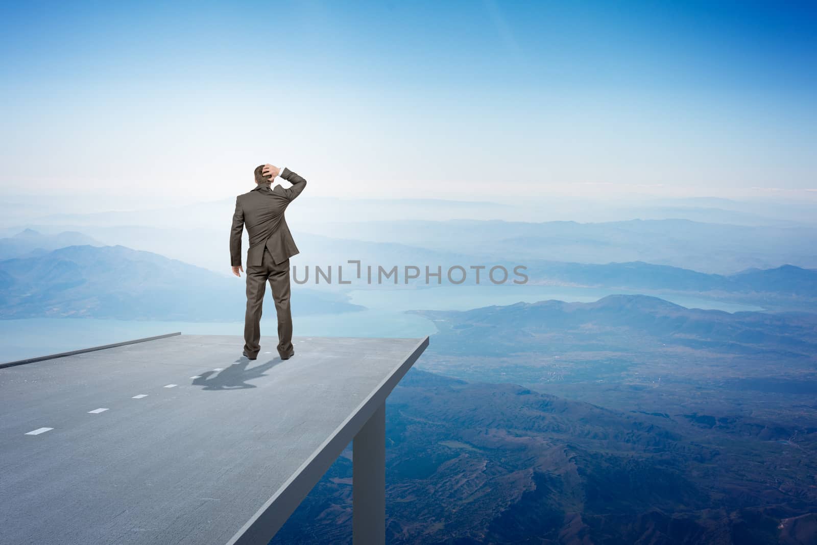 Businessman standing on road in sky, rear view. Business concept