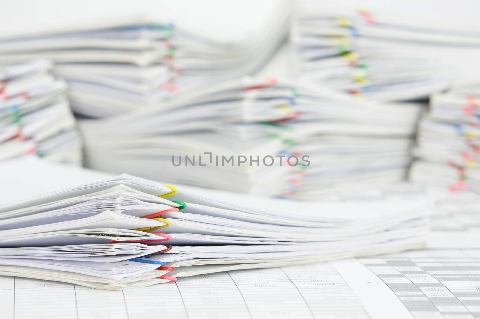 Pile paperwork of report with colorful paperclip on finance account by eaglesky