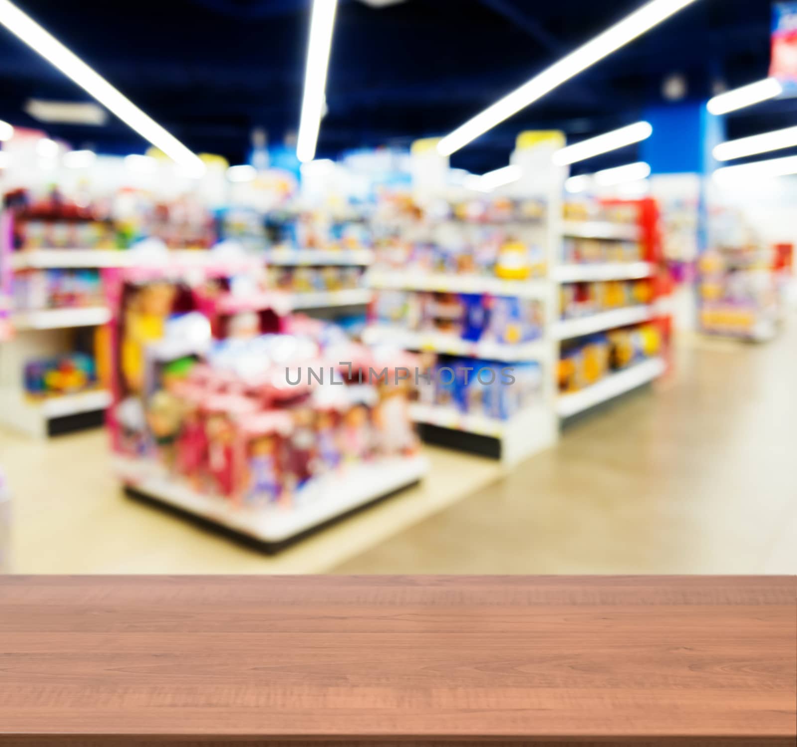 Wooden empty table in front of kids toy store by fascinadora