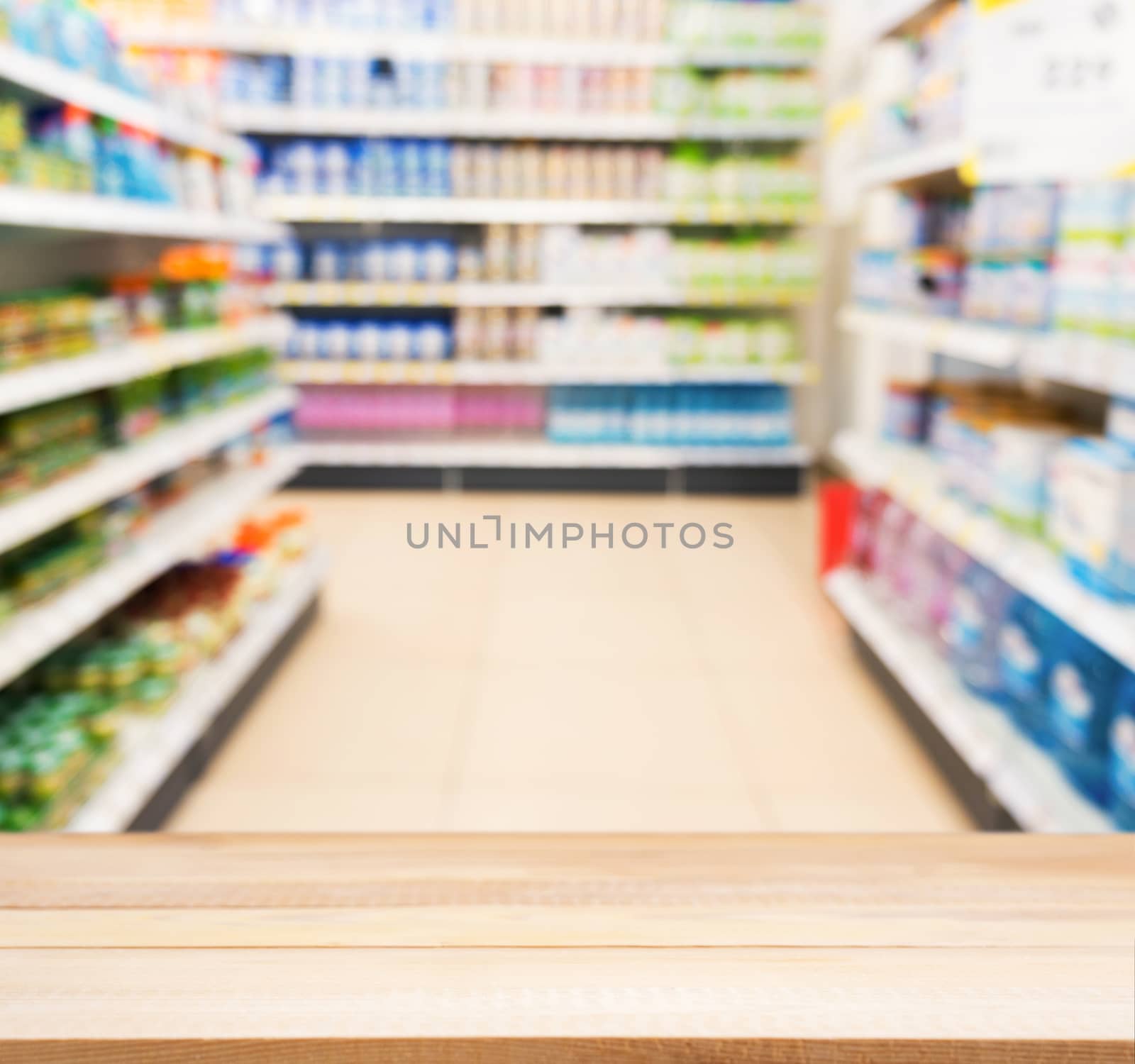 Wooden board empty table in front of blurred background. Perspective light wood table over blur in kids toy store. Mock up for display or montage your product.