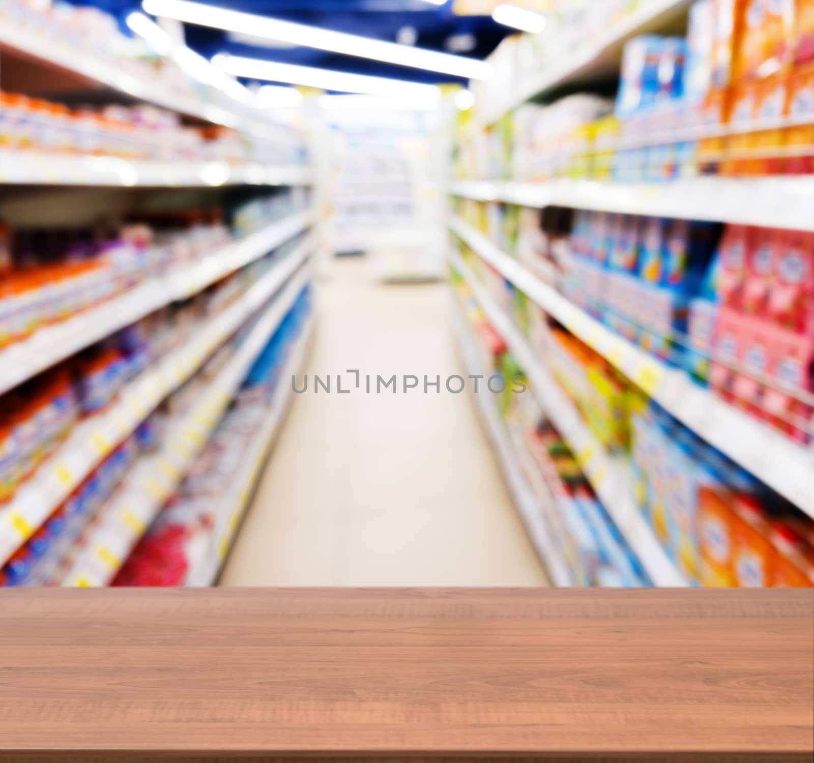 Wooden board empty table in front of blurred background. Perspective dark wood table over blur of baby foods jars in store. Mock up for display or montage your product.