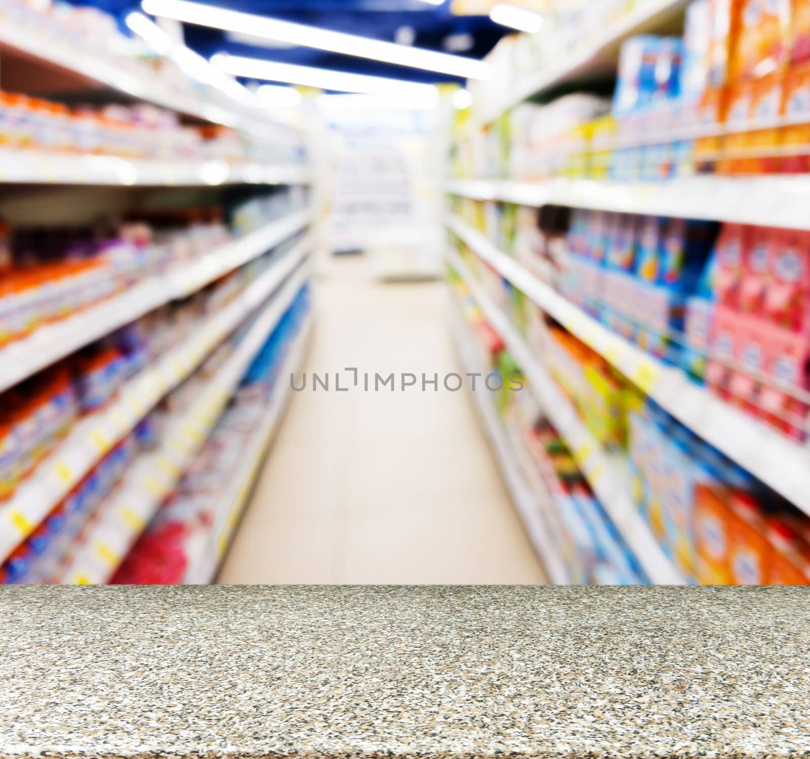 Marble board empty table in front of blurred background. Perspective marble table over blur of baby foods jars in store. Mock up for display or montage your product.