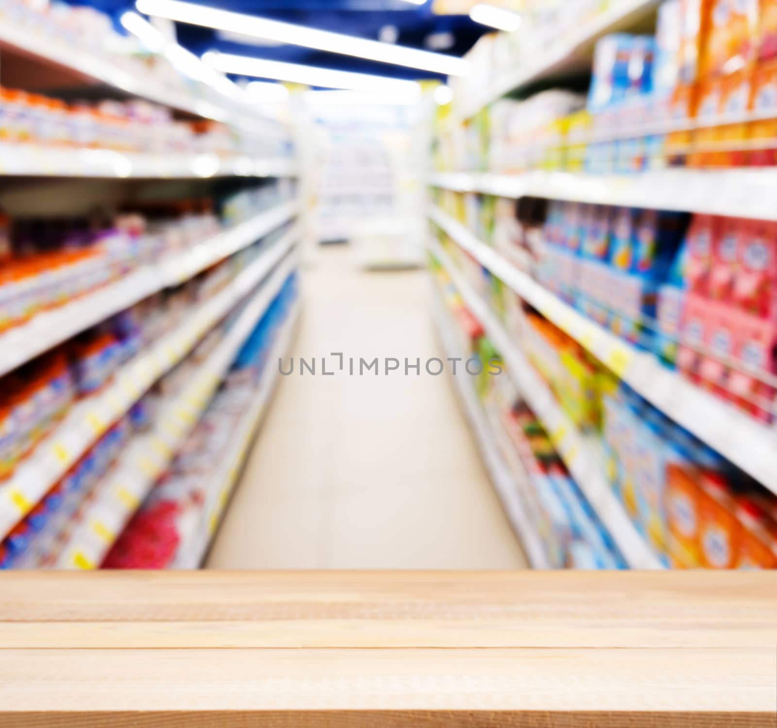 Wooden board empty table in front of blurred background. Perspective light wood table over blur of baby foods jars in store. Mock up for display or montage your product.