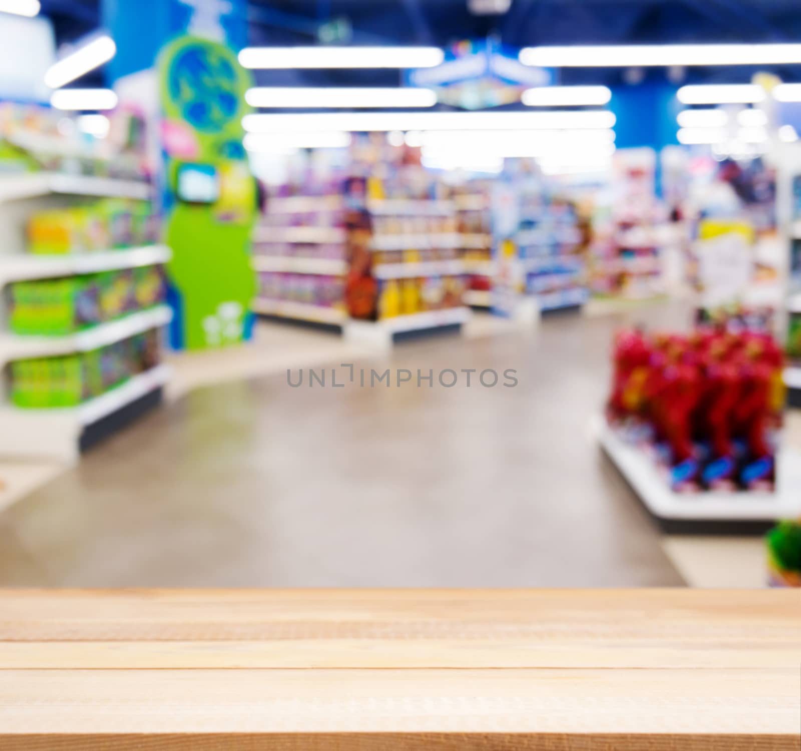 Wooden empty table in front of kids toy store by fascinadora