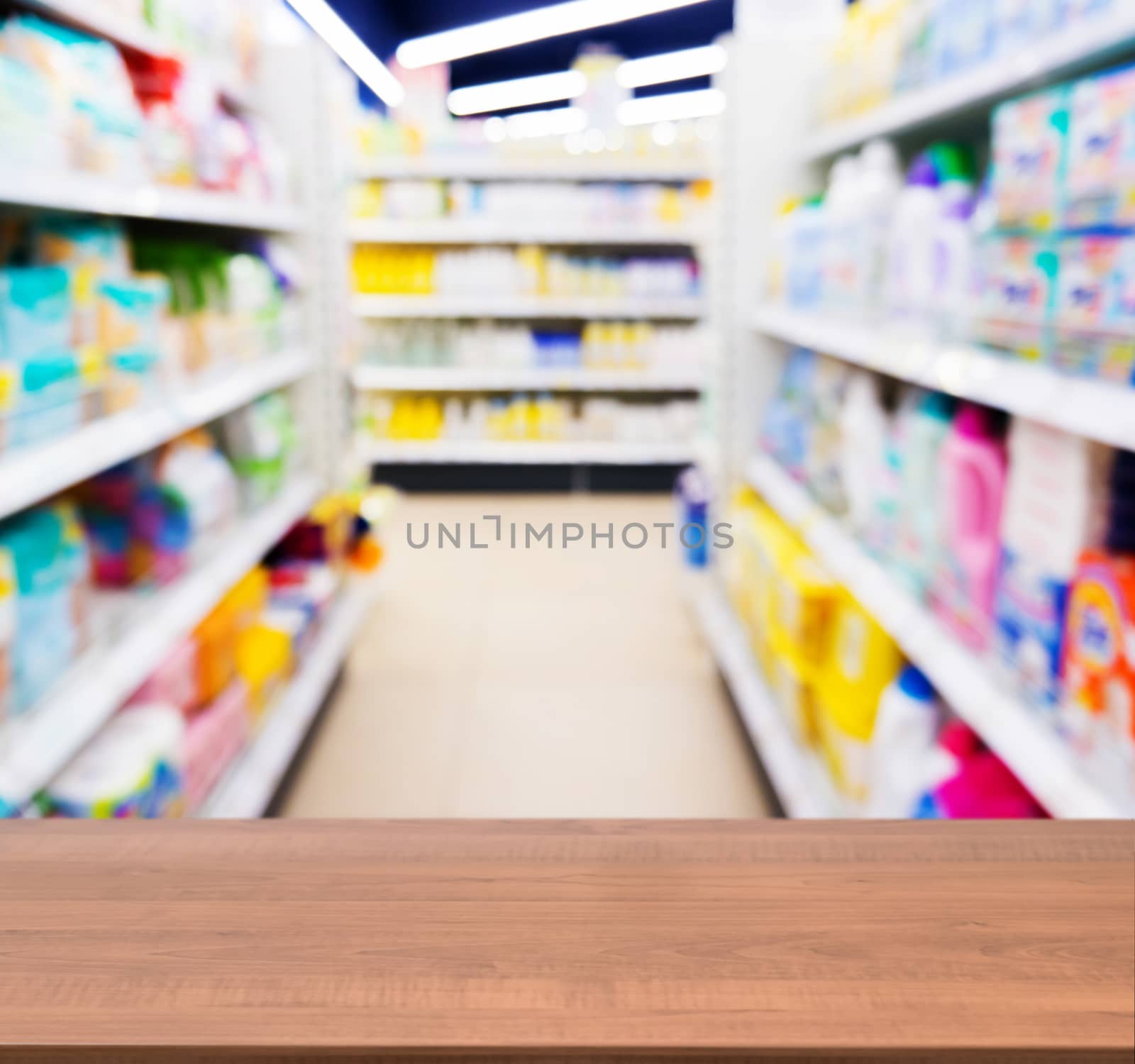 Wooden board empty table in front of blurred background. Perspective dark wood table over blur in kids toy store. Mock up for display or montage your product.