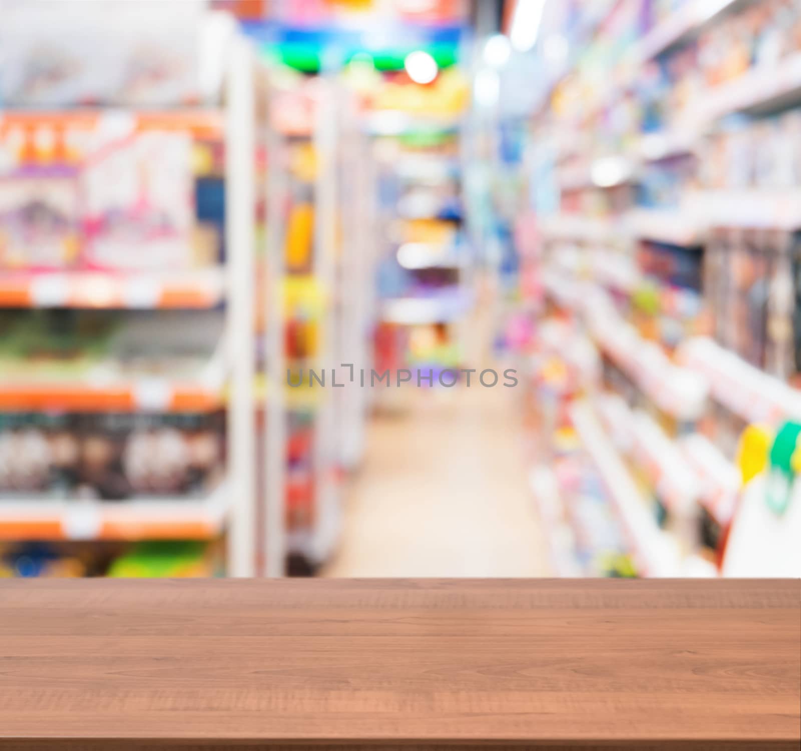 Wooden empty table in front of of kids toy store by fascinadora