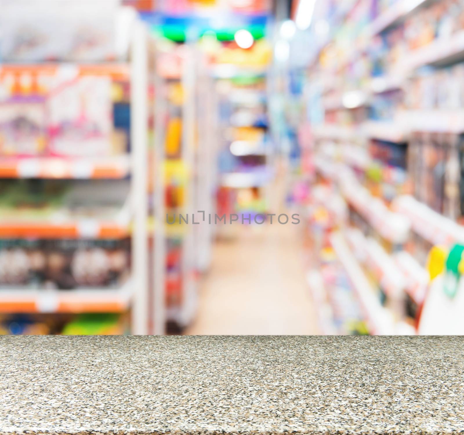 Marble board empty table in front of blurred background. Perspective marble table over blur in kids toy store. Mock up for display or montage your product.