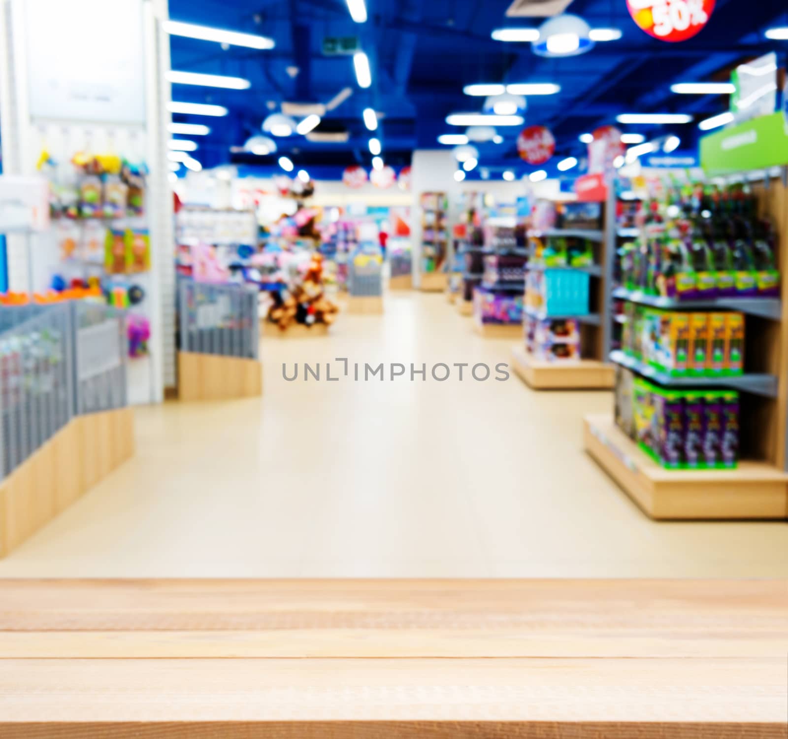 Wooden empty table in blurred of kids toy store by fascinadora