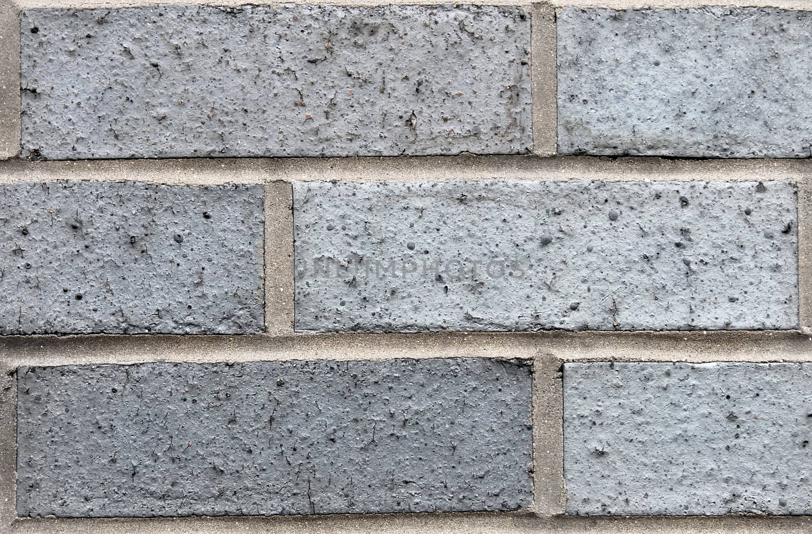 Closeup of a gray brick wall on a modern building.