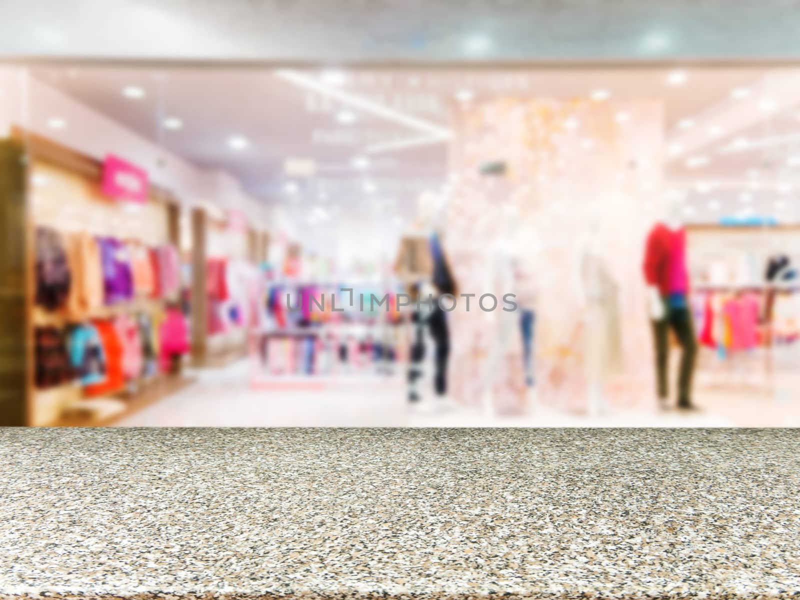 Marble board empty table in front of blurred background. Perspective marble table over blur in dress store. Mock up for display or montage your product.