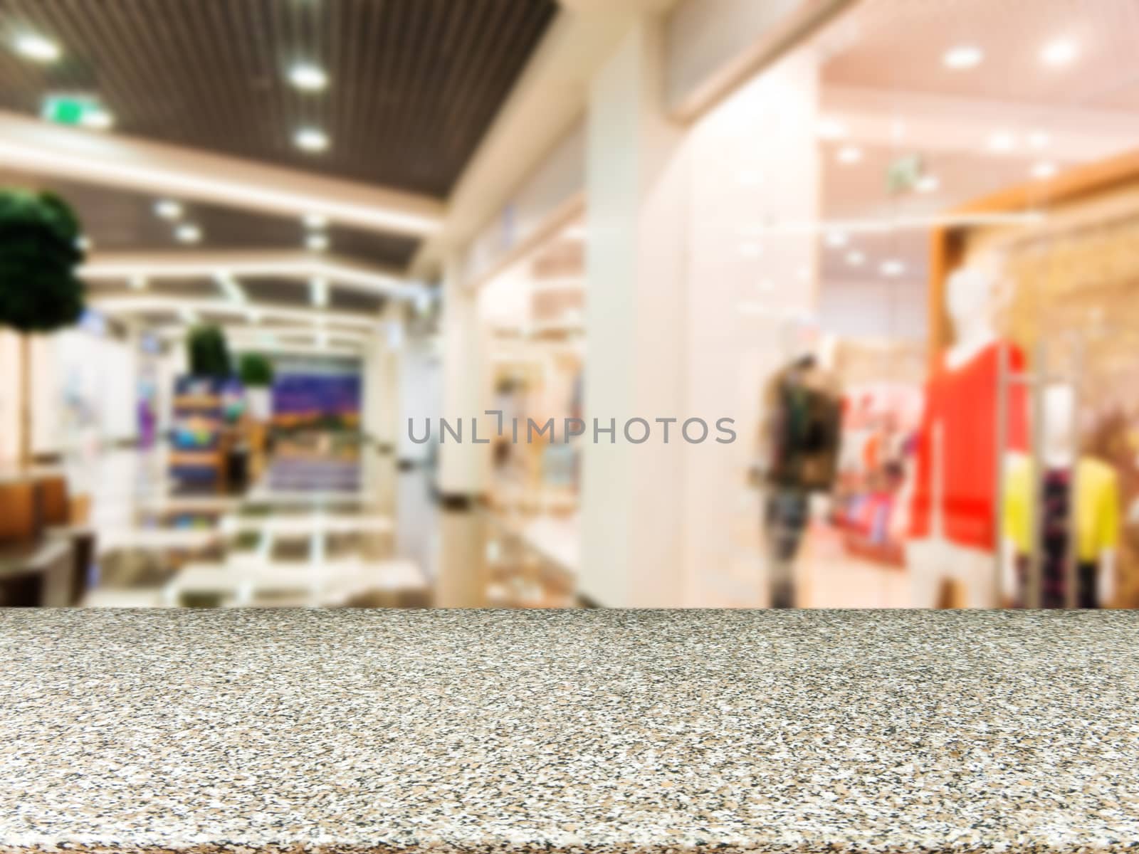 Marble board empty table in front of blurred background. Perspective marble table over blur in shopping mall hall. Mock up for display or montage your product.