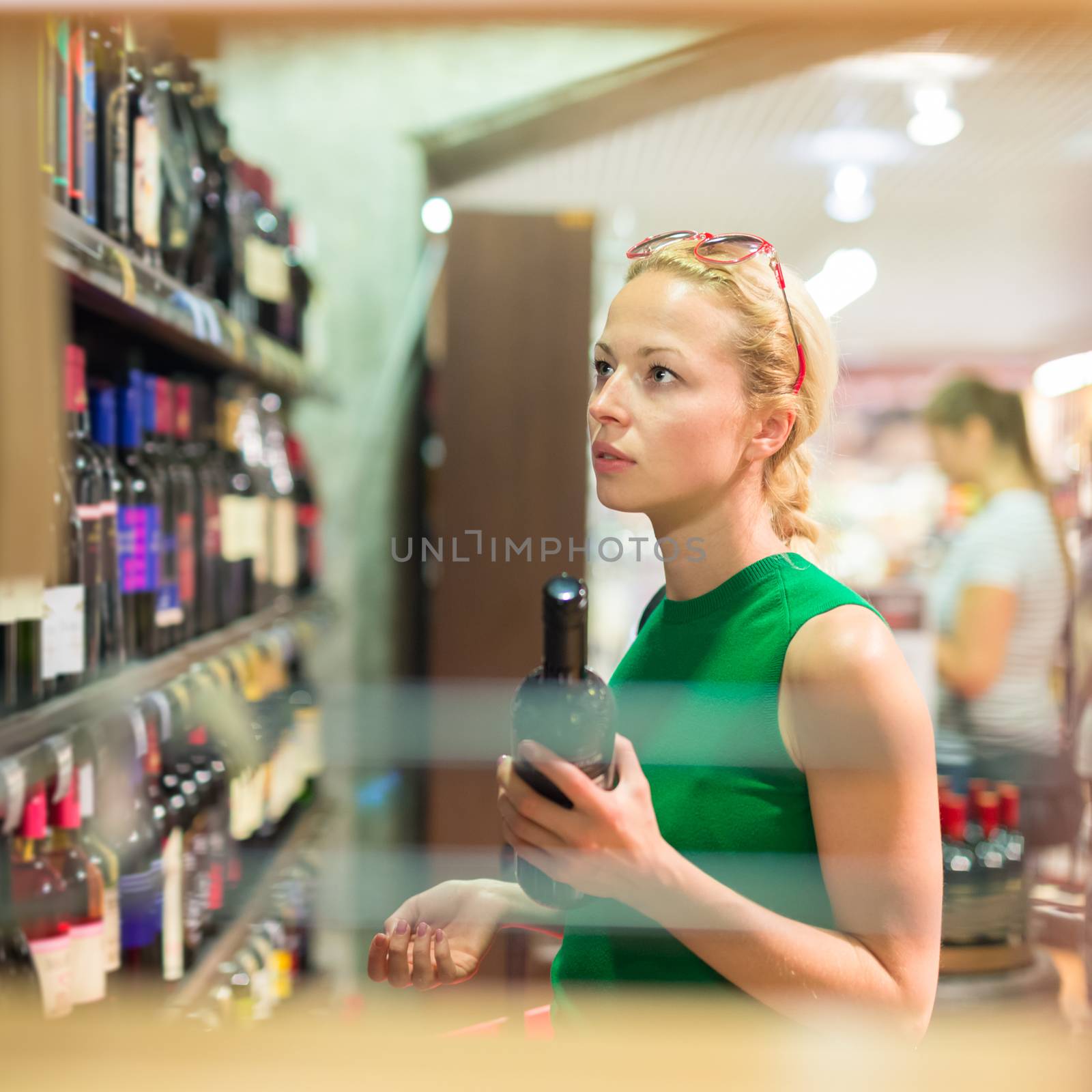 Woman shopping groceries at supermarket. by kasto