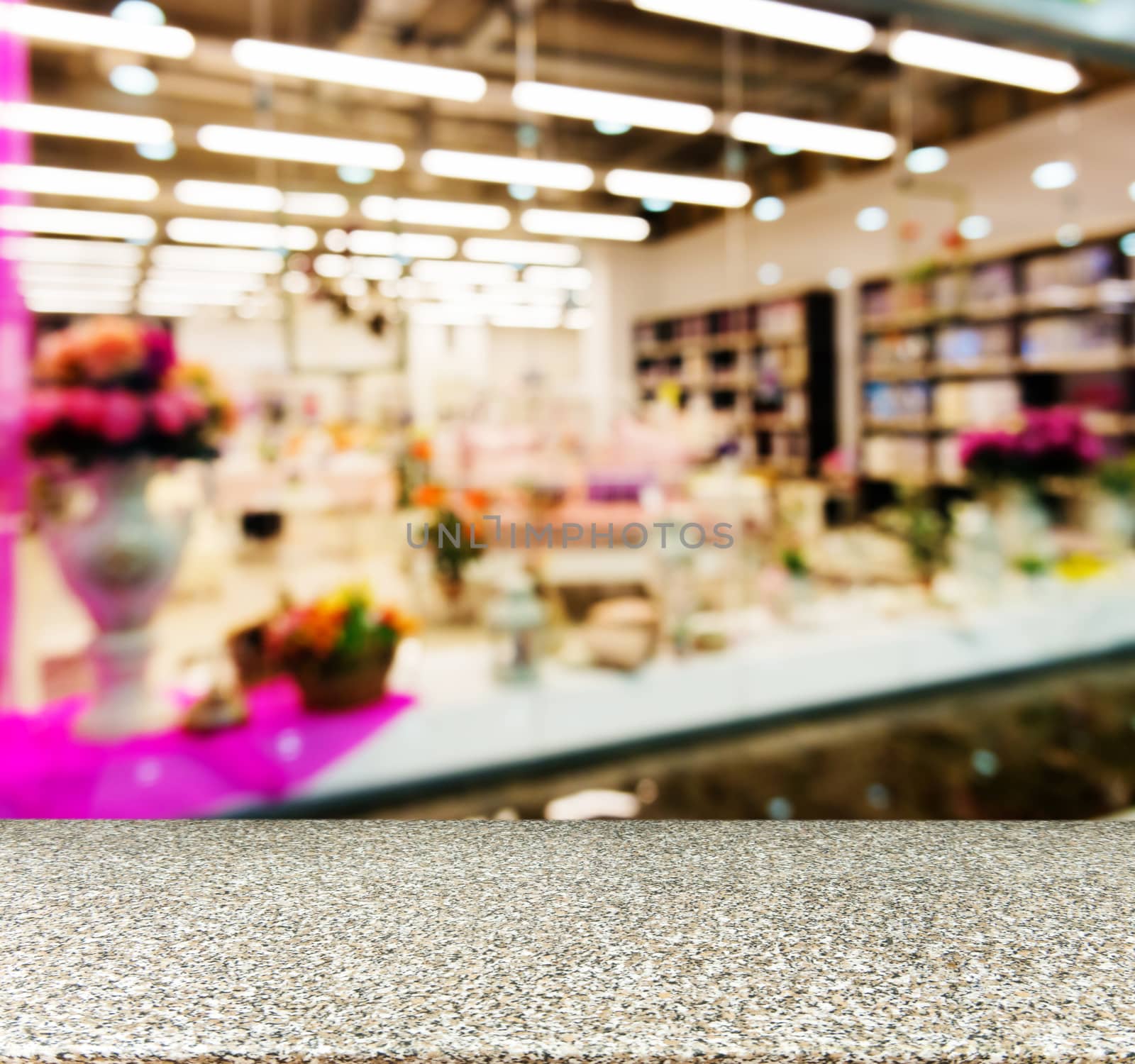 Marble board empty table in front of blurred background. Perspective marble table over blur in shopping mall hall. Mock up for display or montage your product.