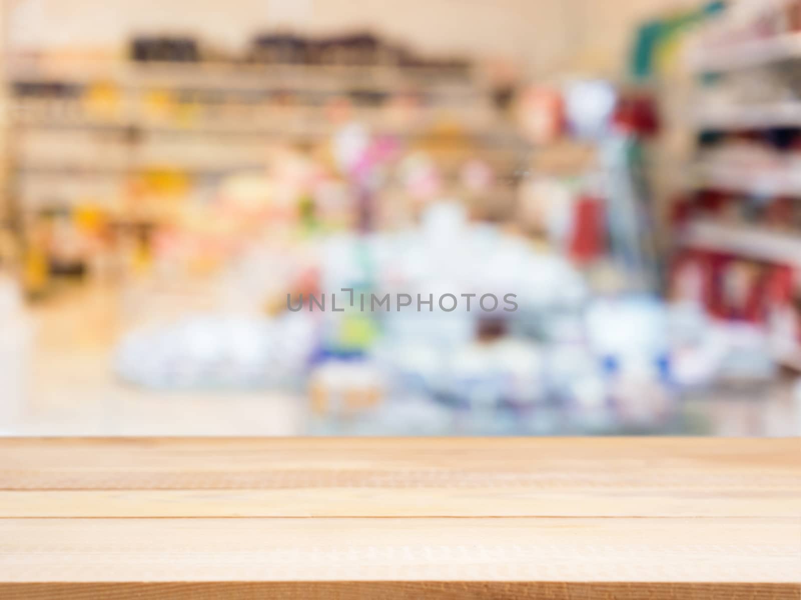 Wooden board empty table in front of blurred background. Perspective light wood table over blur in interior of abstract shop. Mock up for display or montage your product.