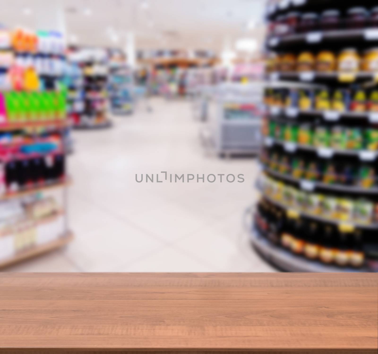 Wooden empty table in front of blurred supermarket by fascinadora