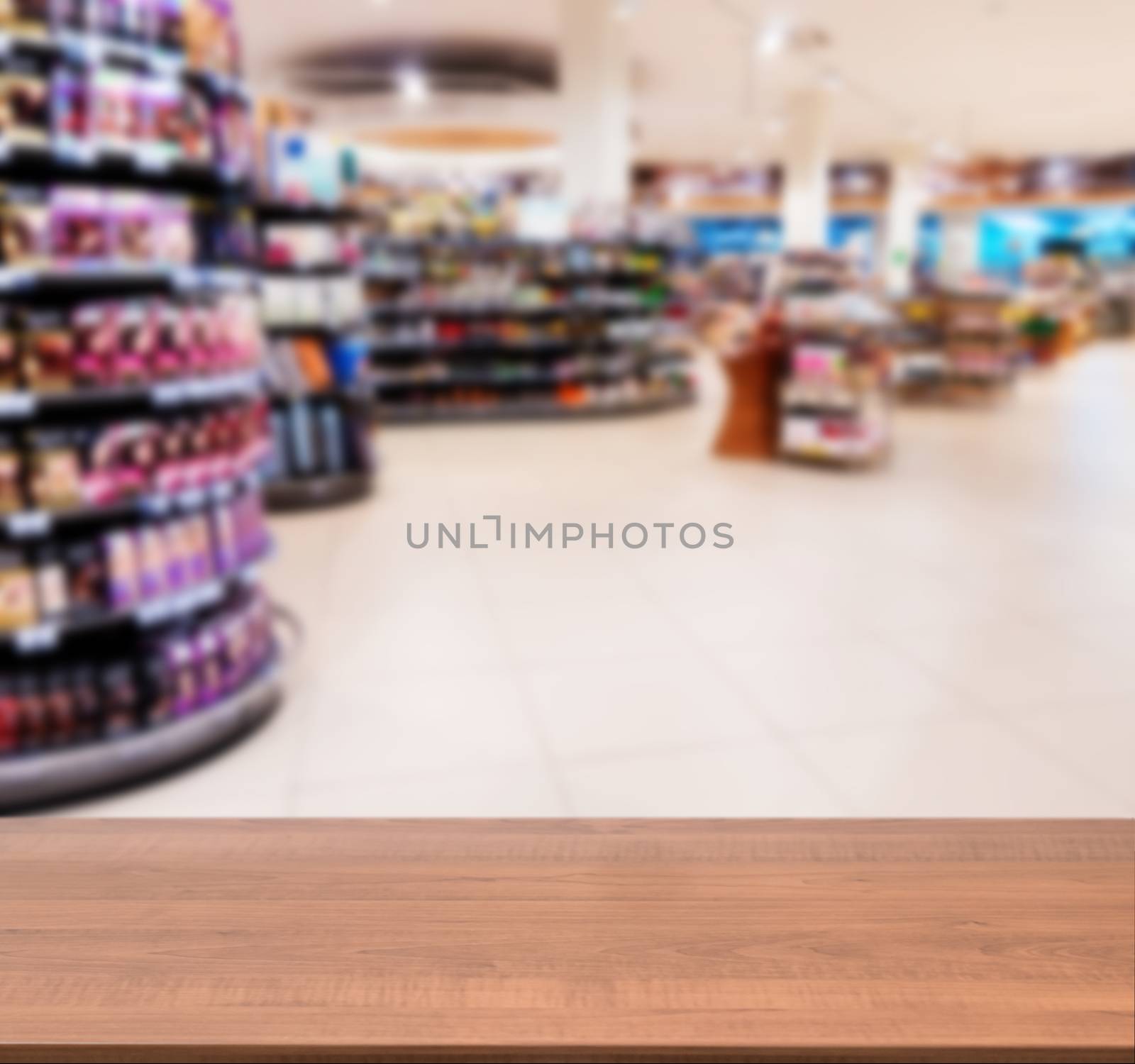 Wooden empty table in front of blurred supermarket by fascinadora