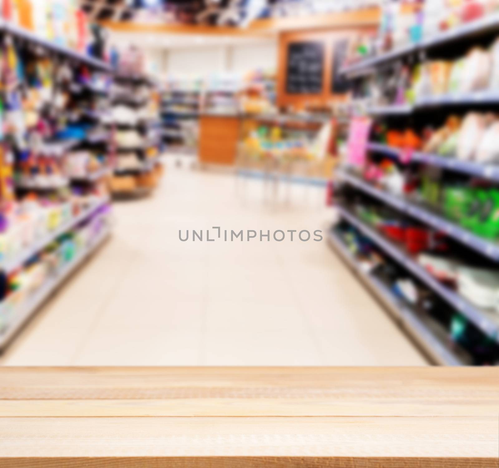 Wooden empty table in front of blurred supermarket by fascinadora