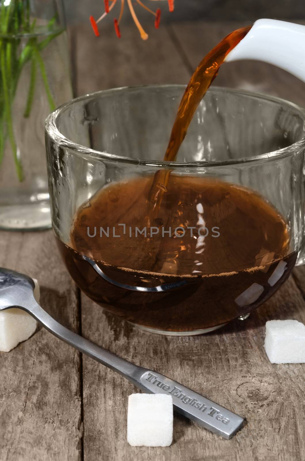 Strong tea is poured into a cup by Gaina