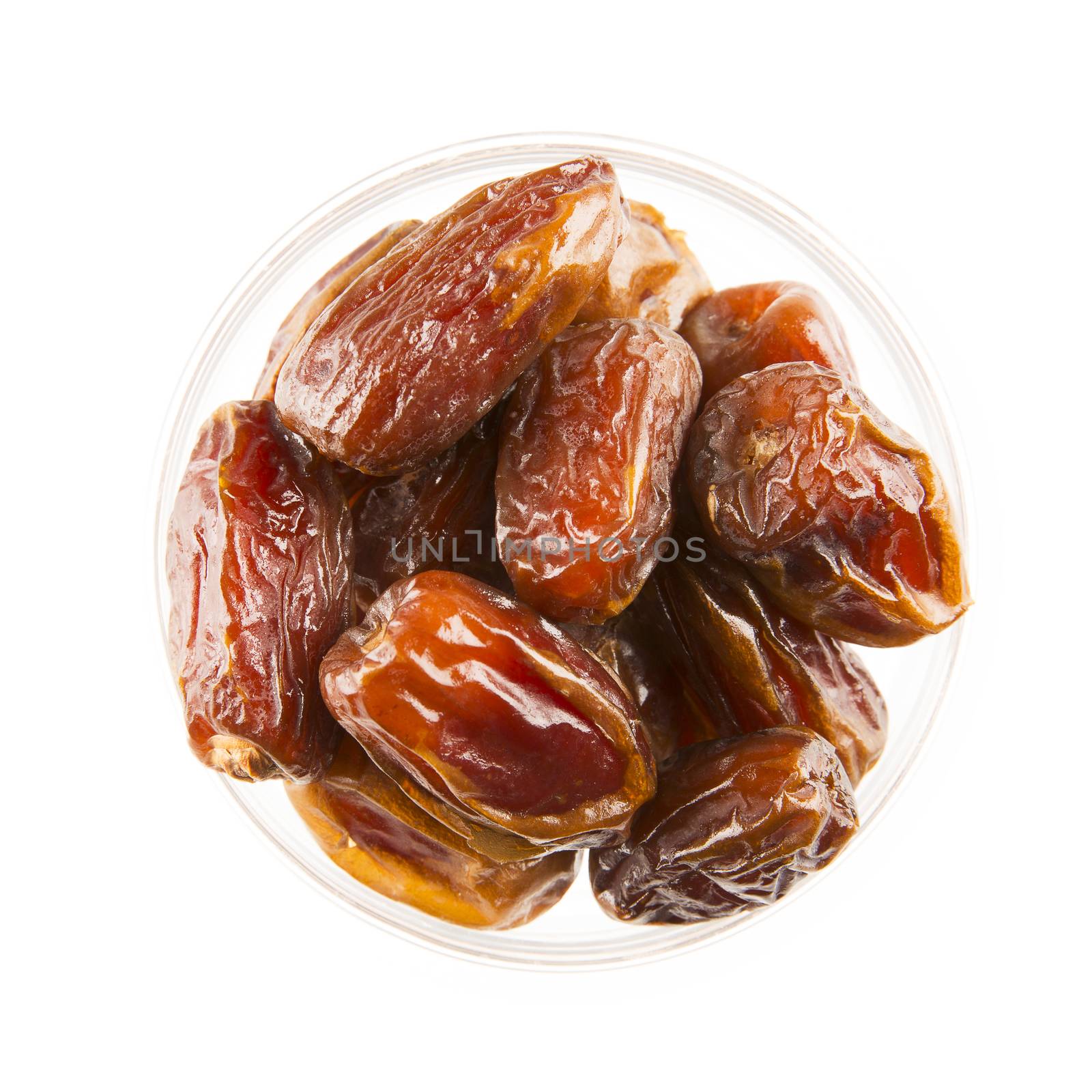 Dried dates in bowl, isolated on white and viewed from above.