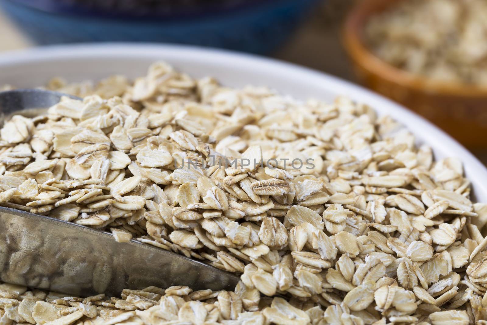 Healthy raw oats with scoop closeup.