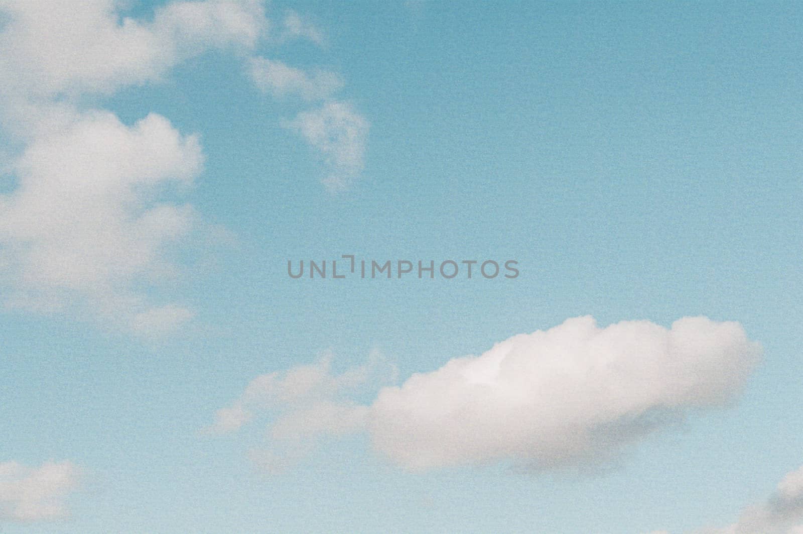 Vintage look sky background with instant camera film grain applied