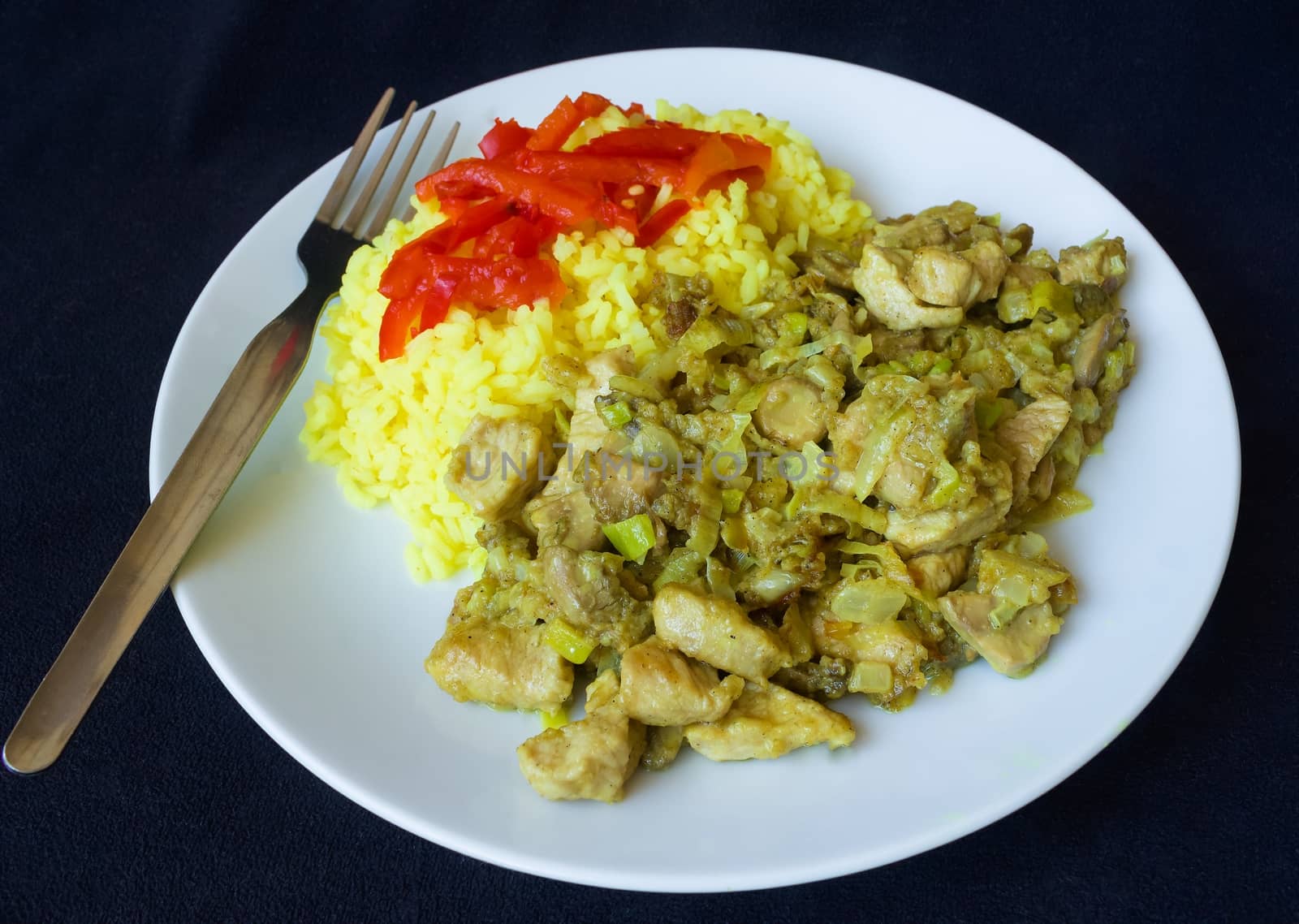 Take a photograph 31. December 2015  Jablonec above Nisou, Czech Republic pork meat smithereens with leek, onion, mushroom and curry rice to white plate dark background