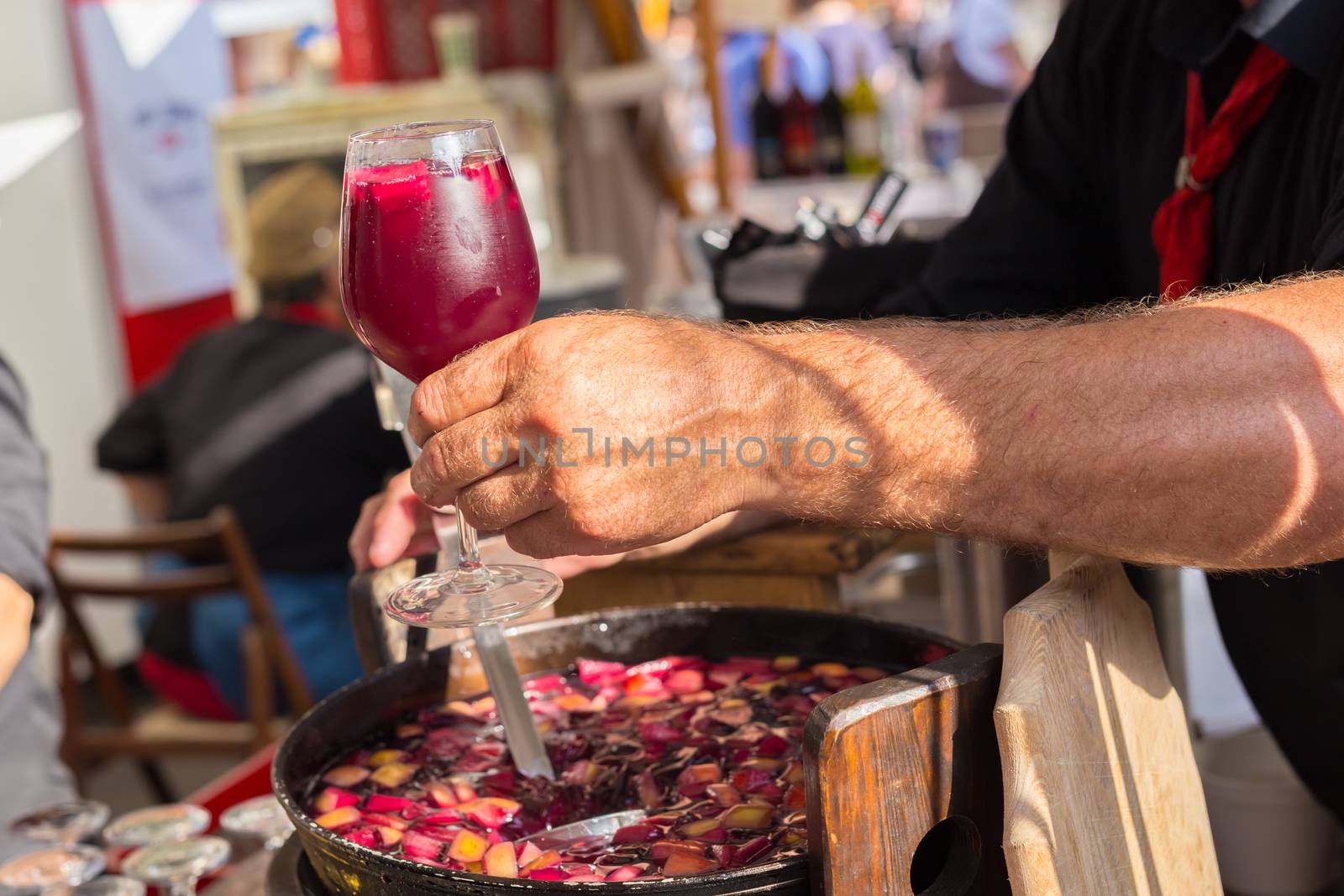 Refreshing sangria with fruits being served on urban street food stall. Urban international kitchen event in Ljubljana, Slovenia, in summertime.