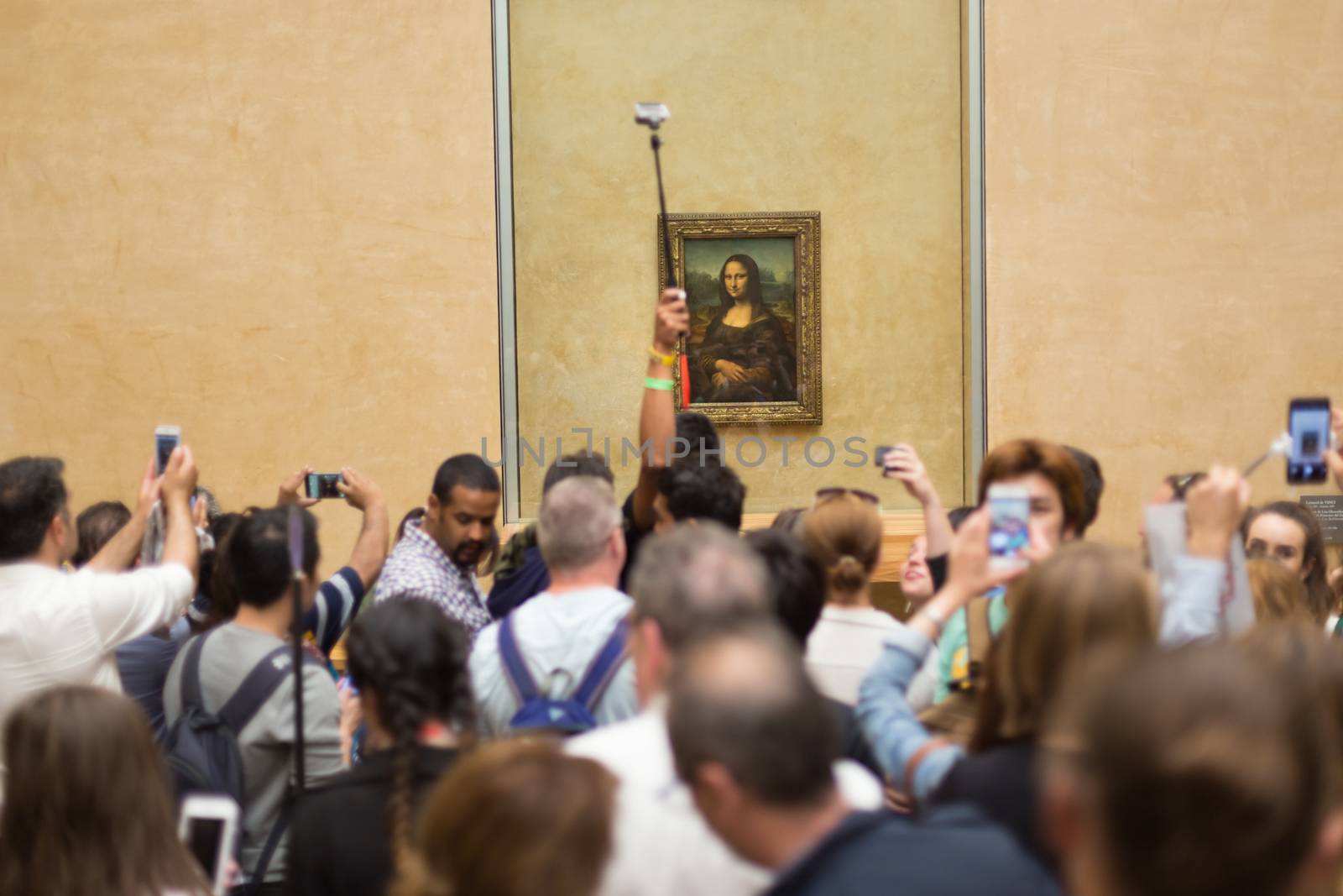 Paris, France - June 12: Crowd of visitors takes photos of Leonardo DaVinci's Mona Lisa, one of world's most famous work of art, at Louvre Museum on 12th of June ,2016 in Paris, France.