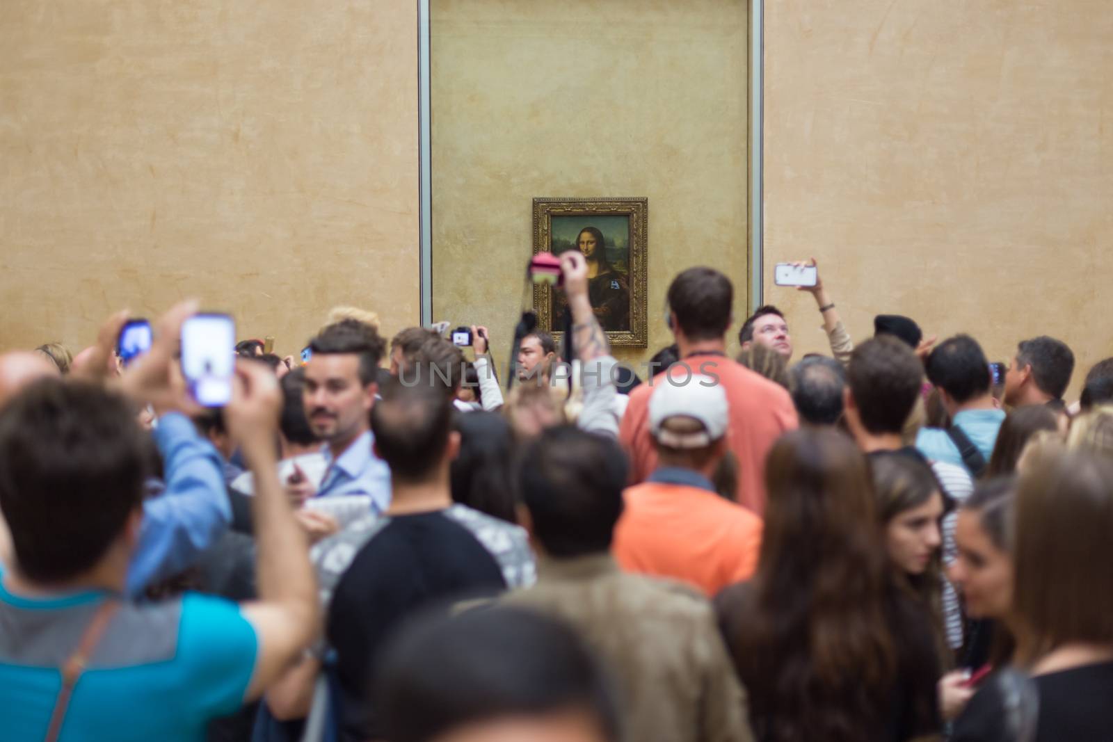 Paris, France - June 12: Crowd of visitors takes photos of Leonardo DaVinci's Mona Lisa, one of world's most famous work of art, at Louvre Museum on 12th of June ,2016 in Paris, France.