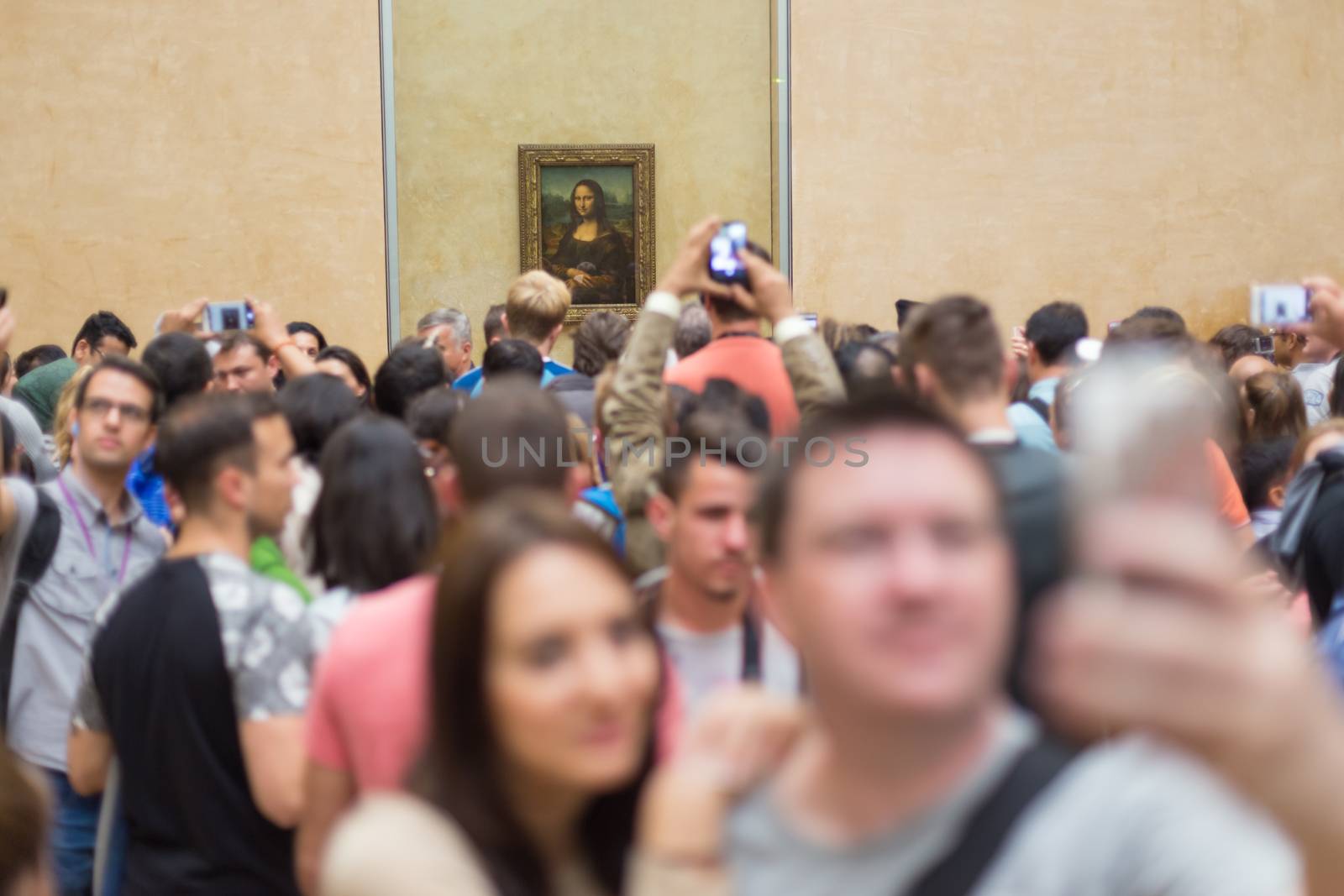 Paris, France - June 12: Crowd of visitors takes photos of Leonardo DaVinci's Mona Lisa, one of world's most famous work of art, at Louvre Museum on 12th of June ,2016 in Paris, France.
