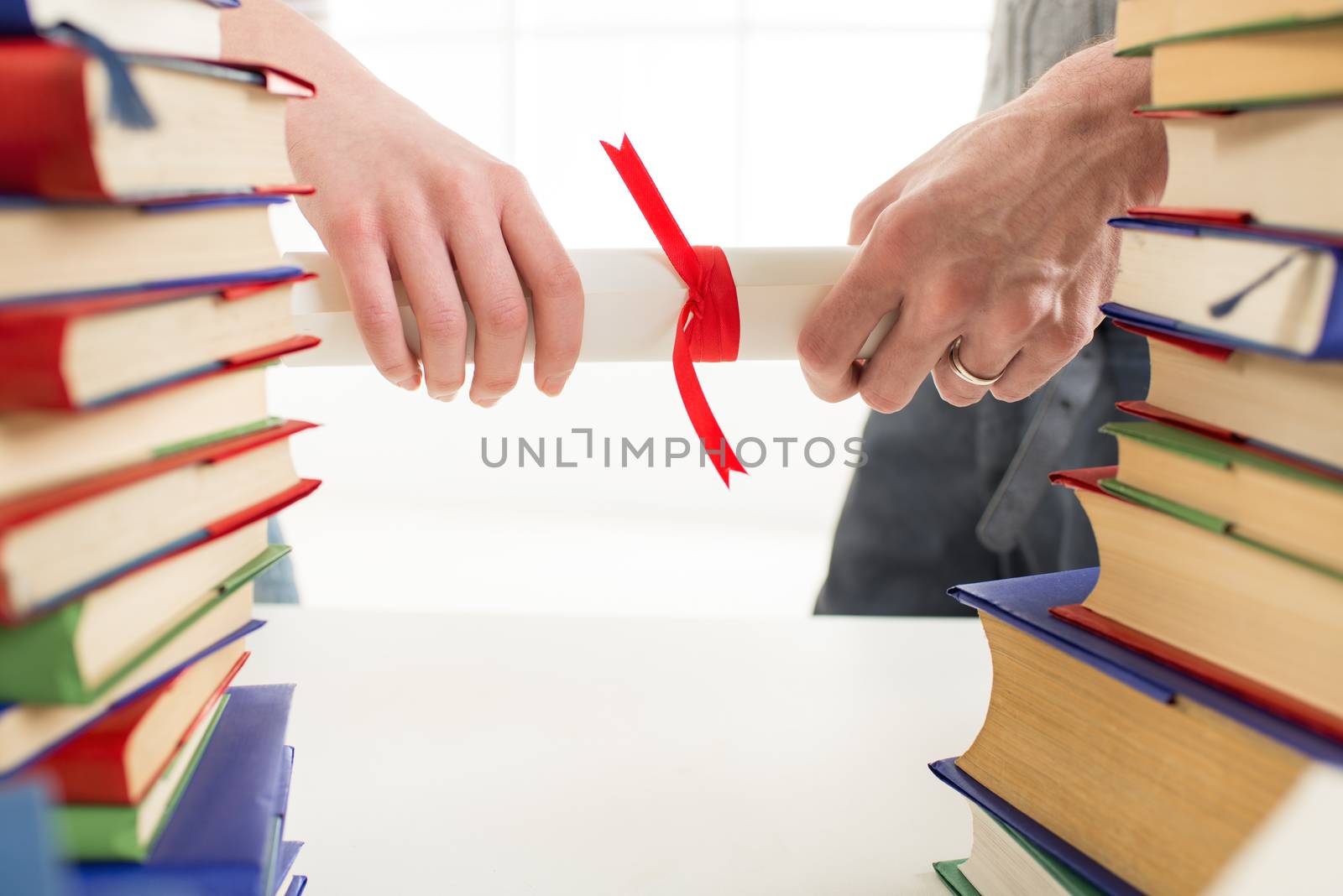 Close-up of woman and man hands is holding diplomas