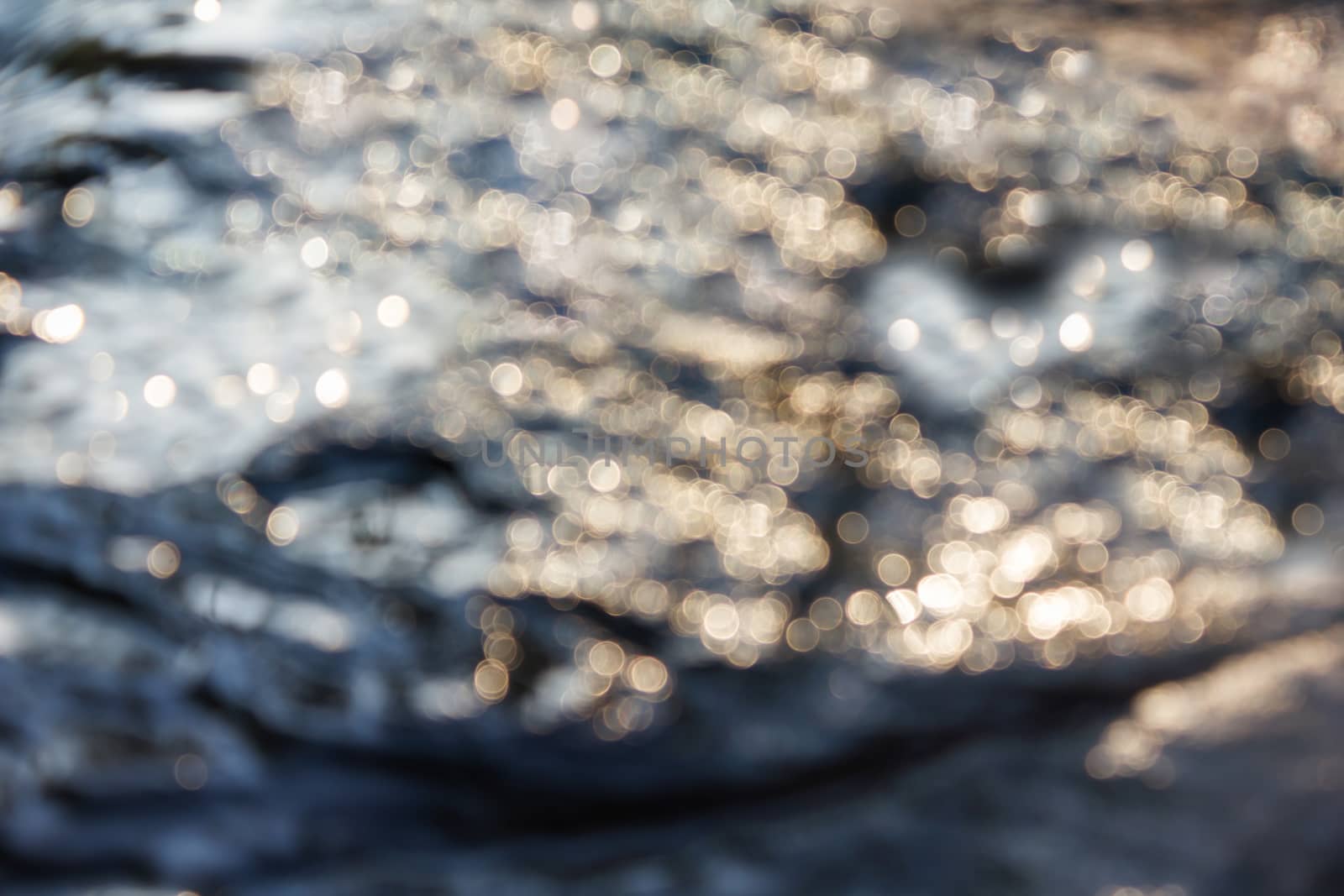 Dreamy abstract sparkle shining bokeh light crystalline water in river surface romantic background 