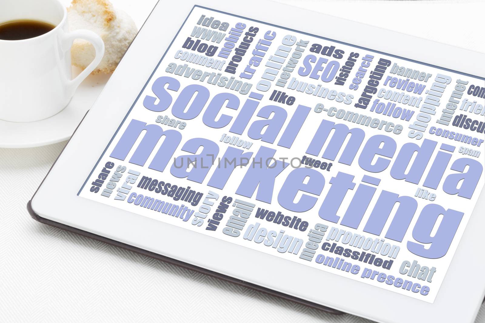 social media marketing concept - a word cloud on a digital tablet with a cup of coffee