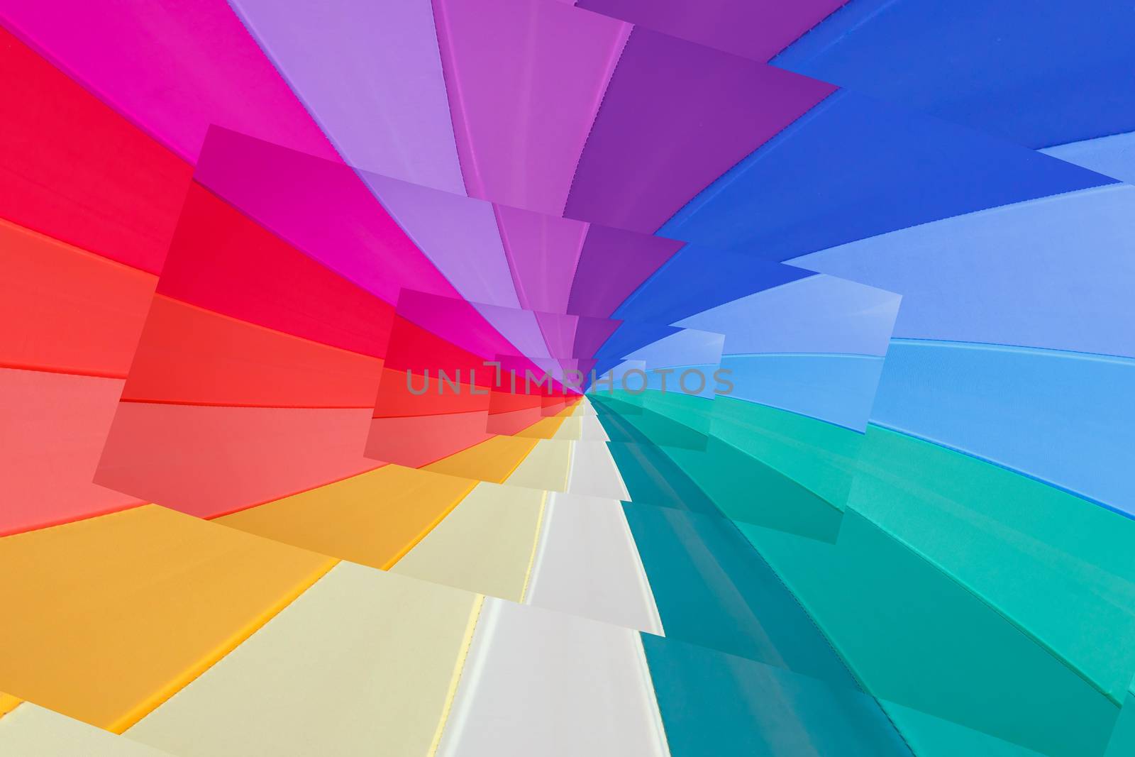 multicoloured wedges umbrella  seem a vortex of colours