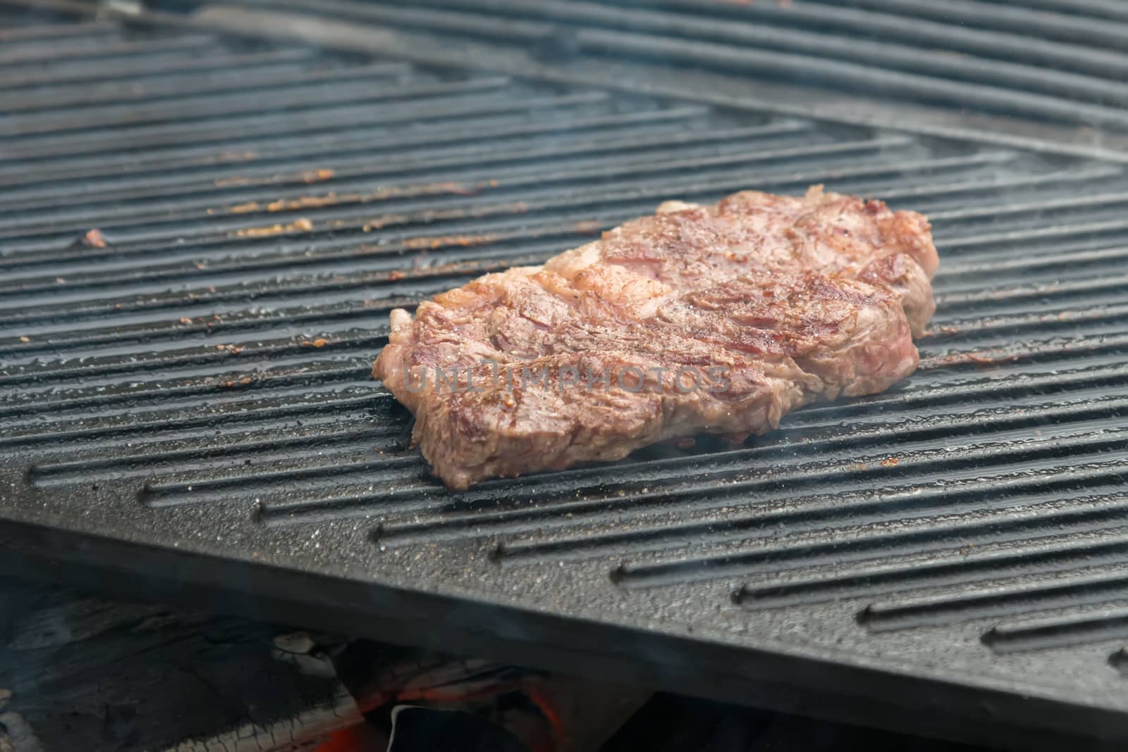 beef steaks on the grill by vlaru