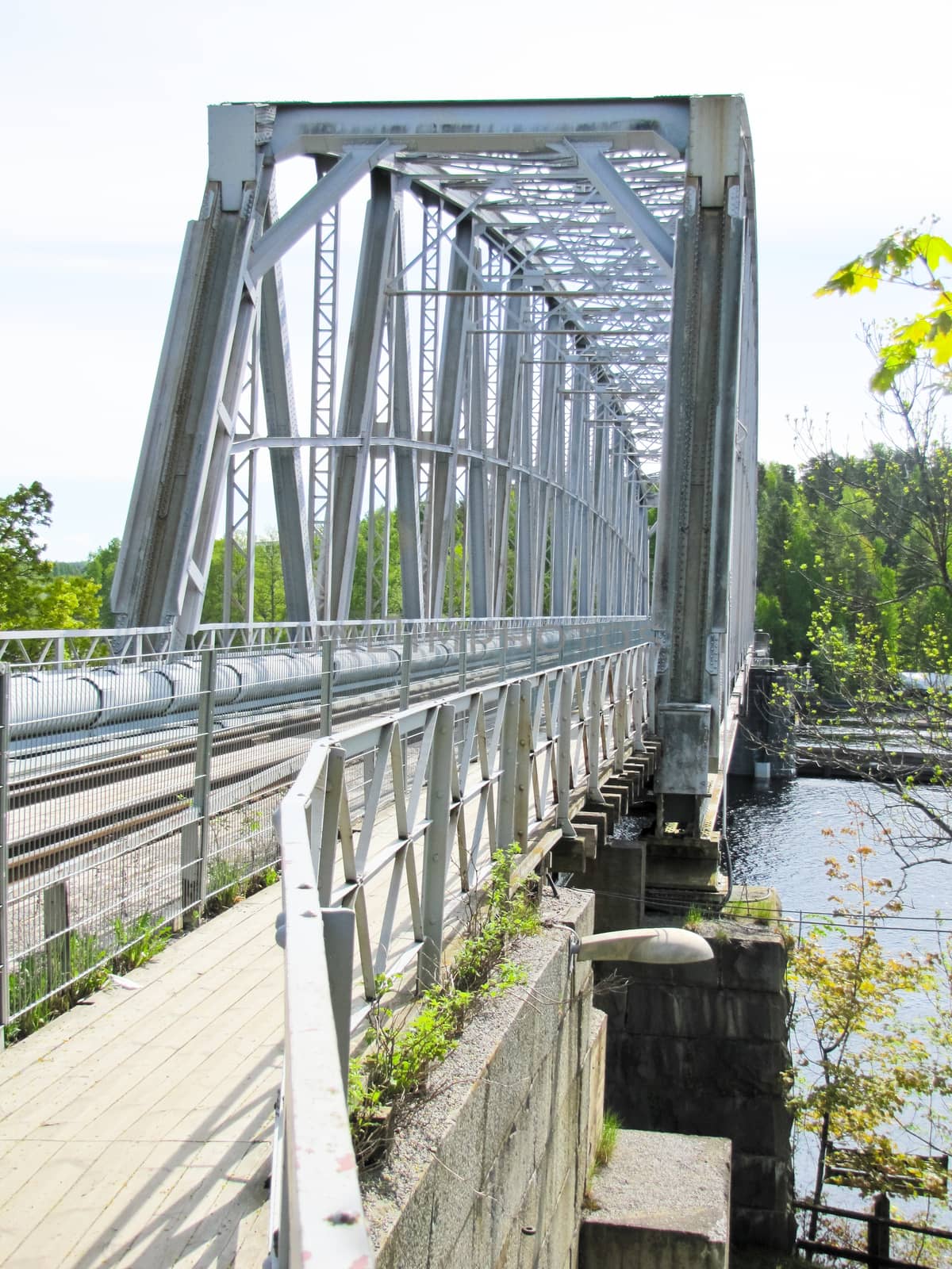 
grey metal bridge over the river