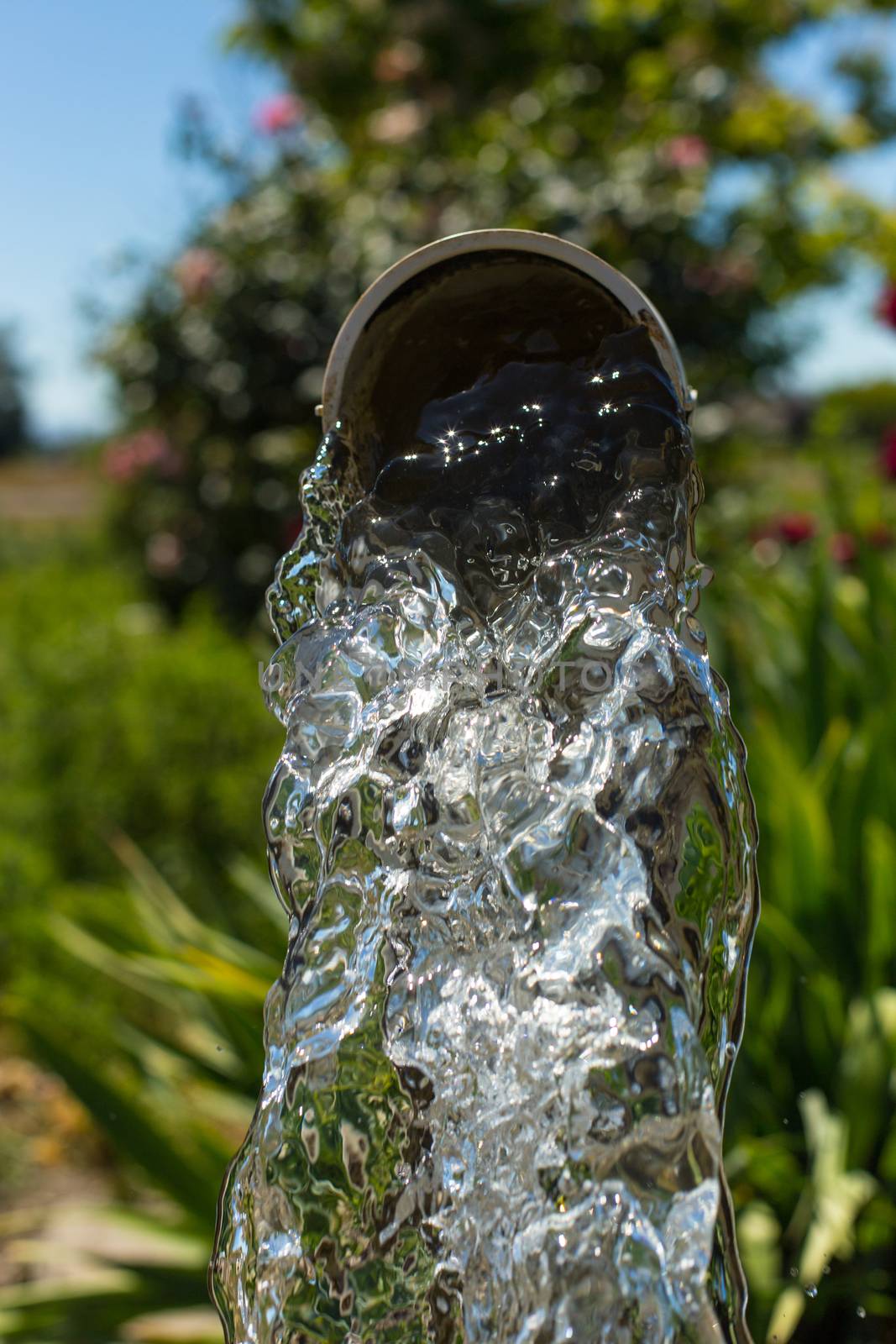 Water flowing from a well pipe by johnborda