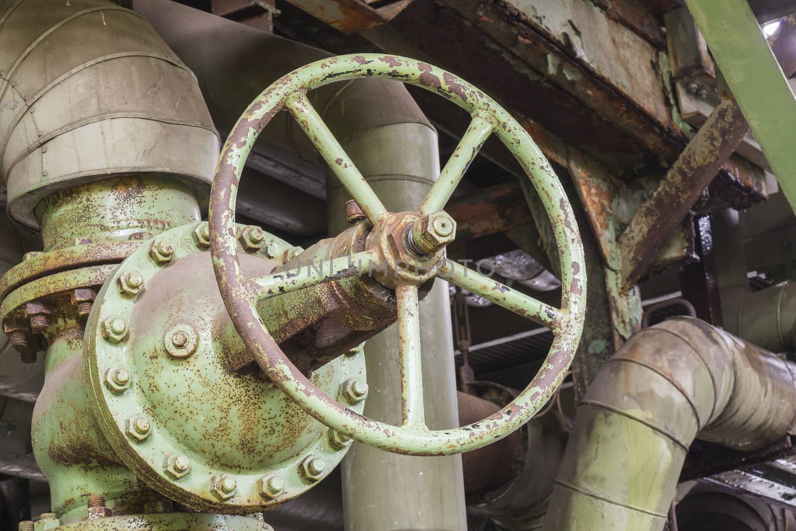 Industrial rusty valve in an abandoned factory
