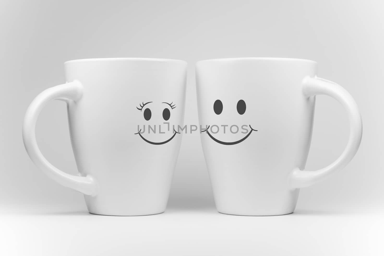 Two white mugs in a mirrored arrangement in high-key with facial expressions
