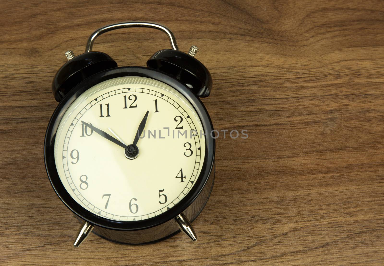 Old classic clock with the instructions lies on a wooden counter in vintage style. flat, horizontal view.
