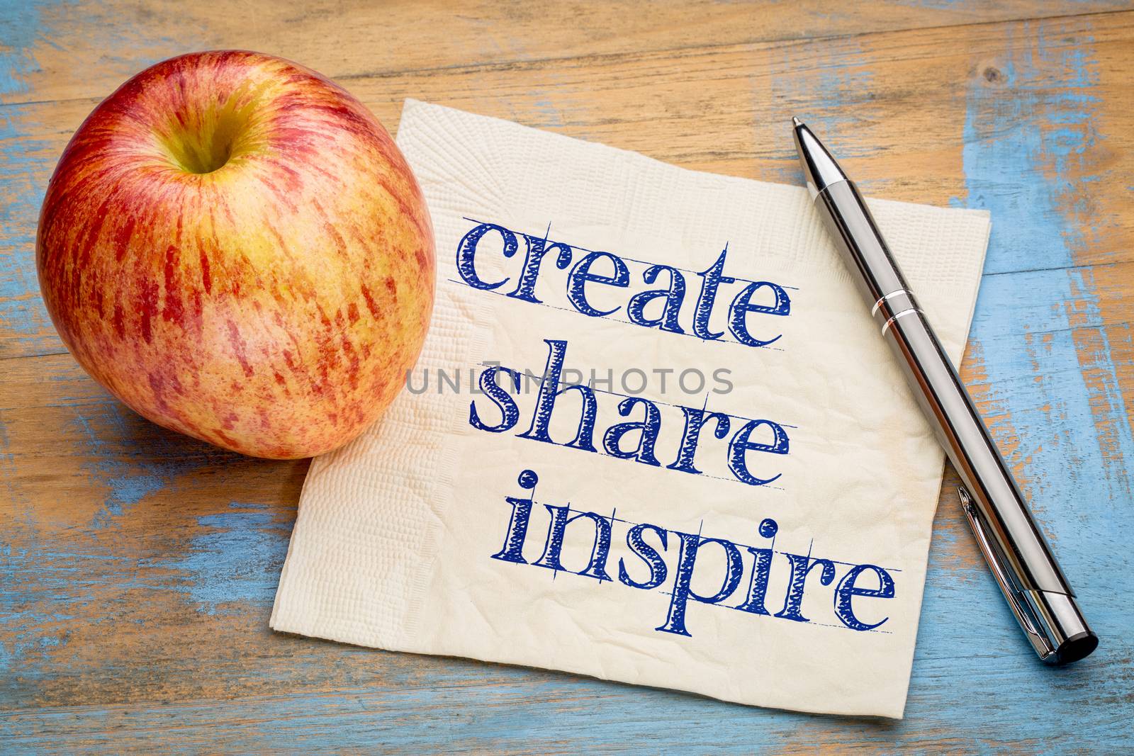 create, share inspire motivational words - handwriting on a napkin with a fresh apple