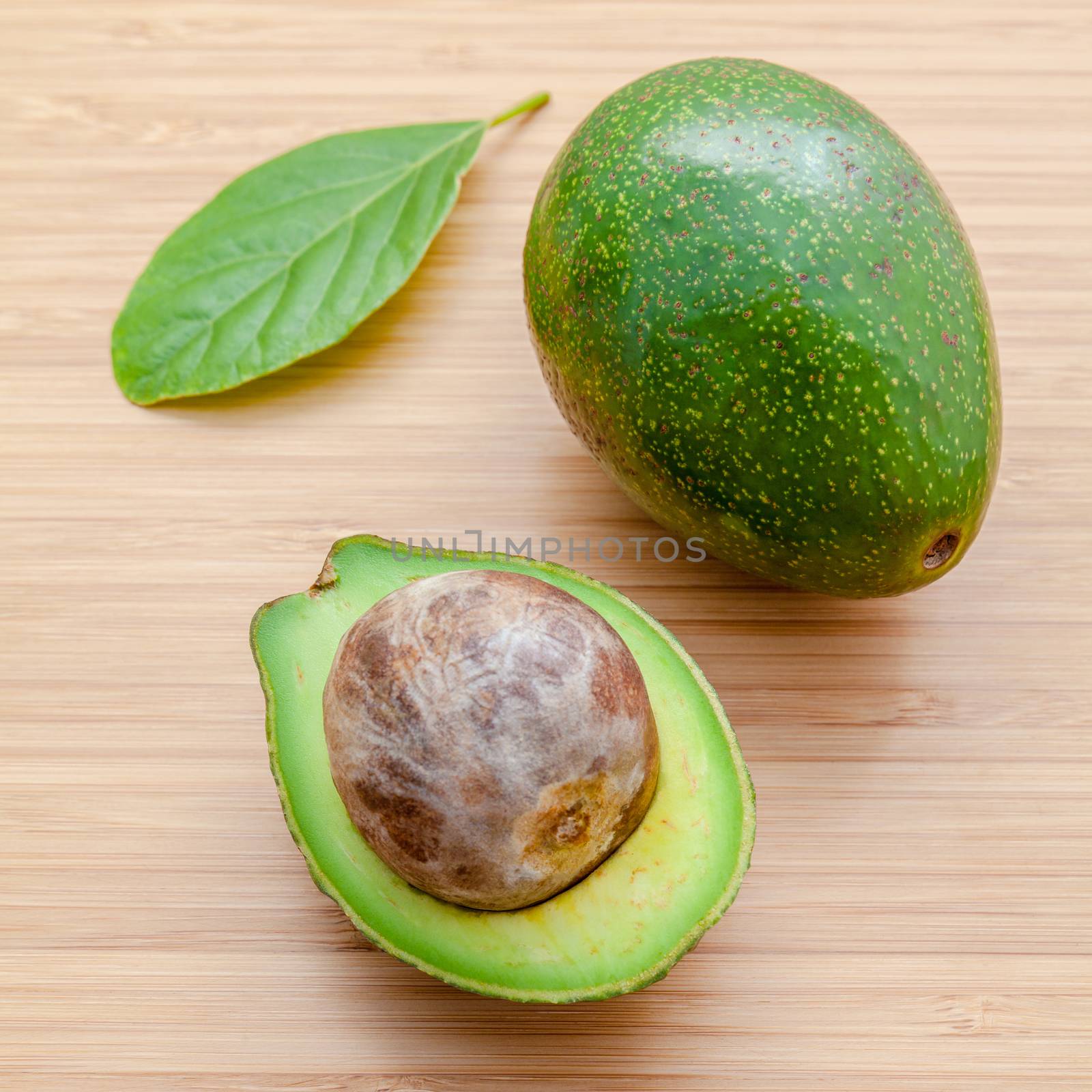 Fresh avocado on wooden background. Organic avocado healthy food by kerdkanno