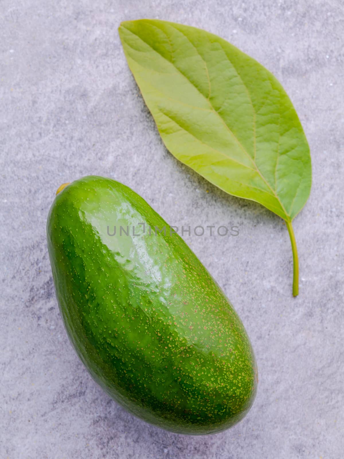 Fresh avocado on stone background. Organic avocado healthy food  by kerdkanno