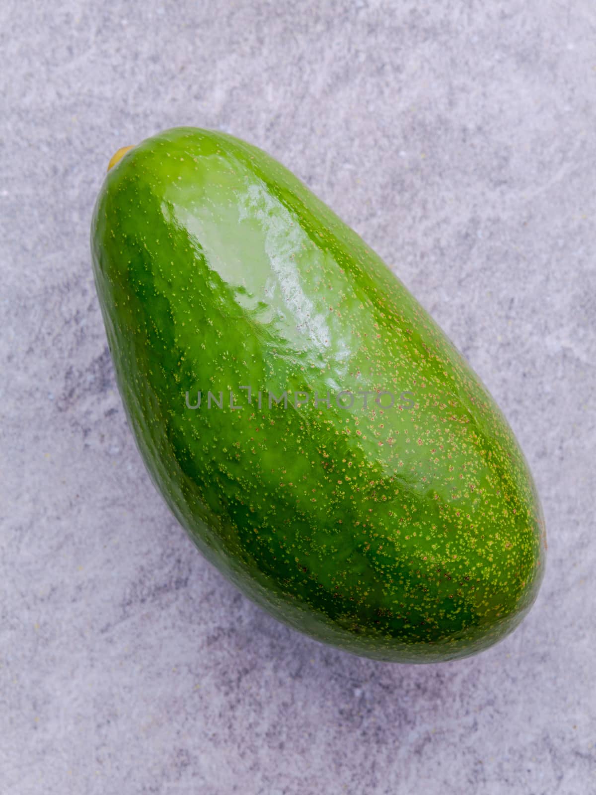 Fresh avocado on stone background. Organic avocado healthy food concept.
The avocado is popular in vegetarian cuisine and weight control.