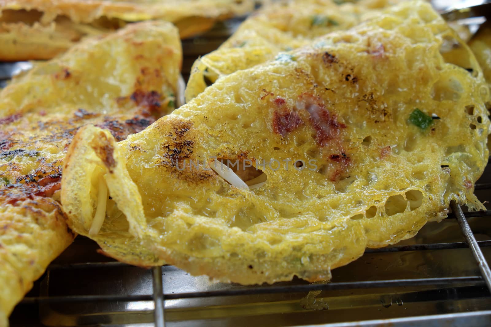 Vietnam food, banh xeo or vietnamese pancake make from rice flour and filled with a shrimp, meat, soya bean sprouts, is popular Viet Nam street food